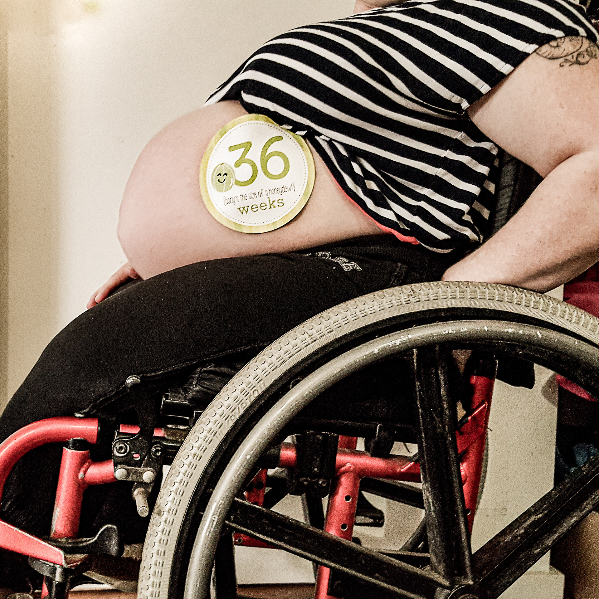 Malissa's baby bump at 36 weeks, while sitting her wheelchair