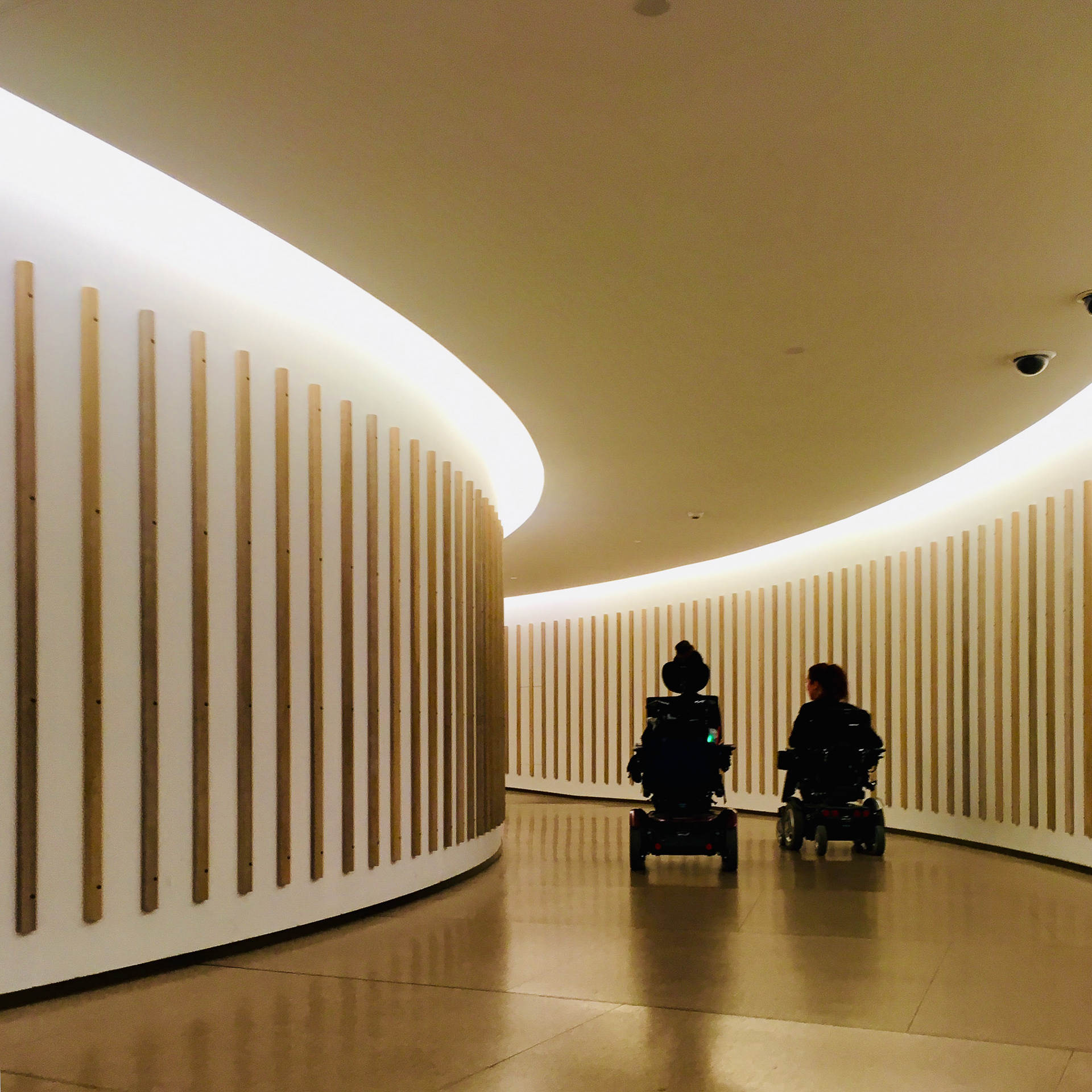 2 wheelchair users on a curved pathway