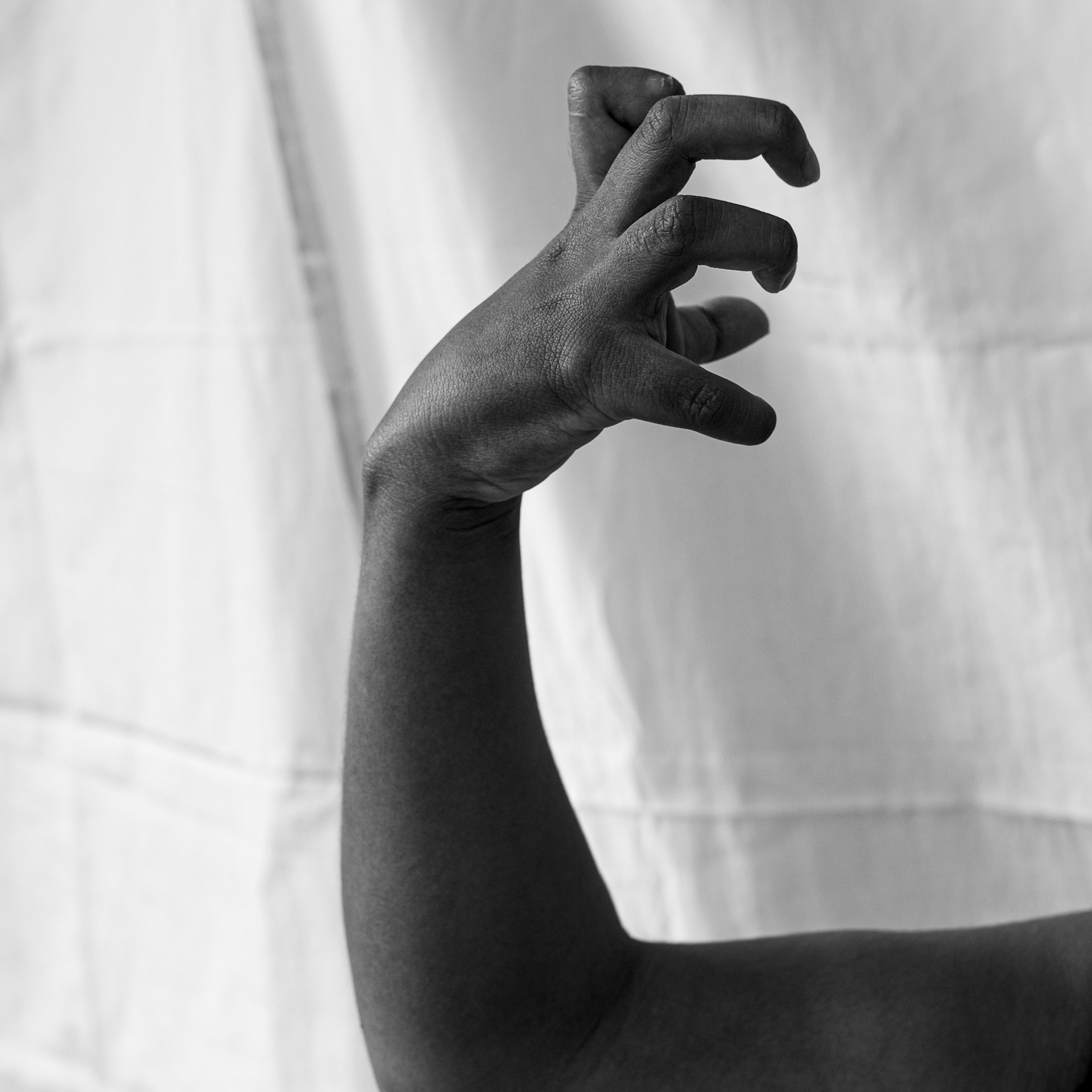 A black and white image of Marusha's arm and clawed fingers