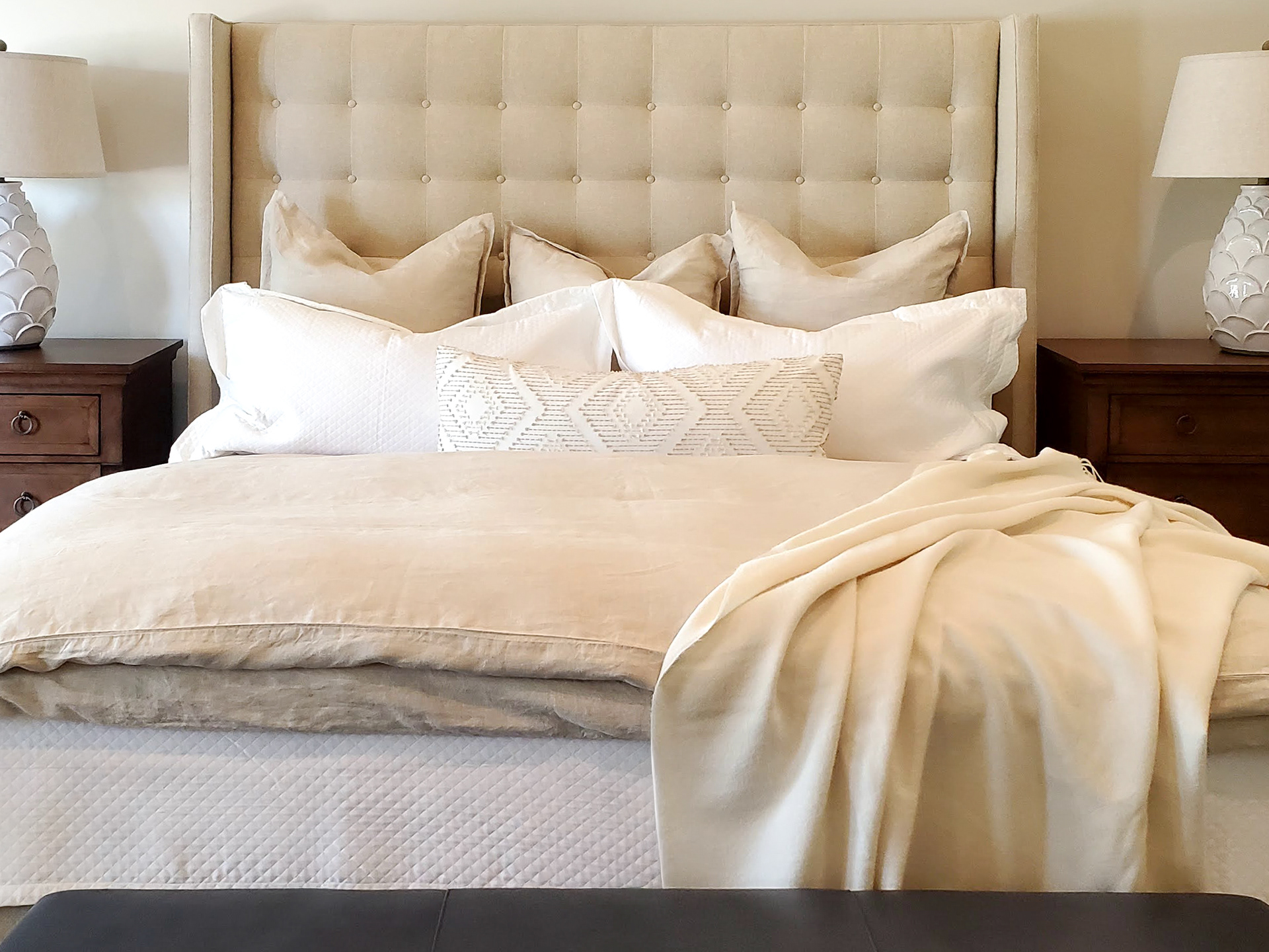Capturing the tactile luxury of layered linens and tufted details.