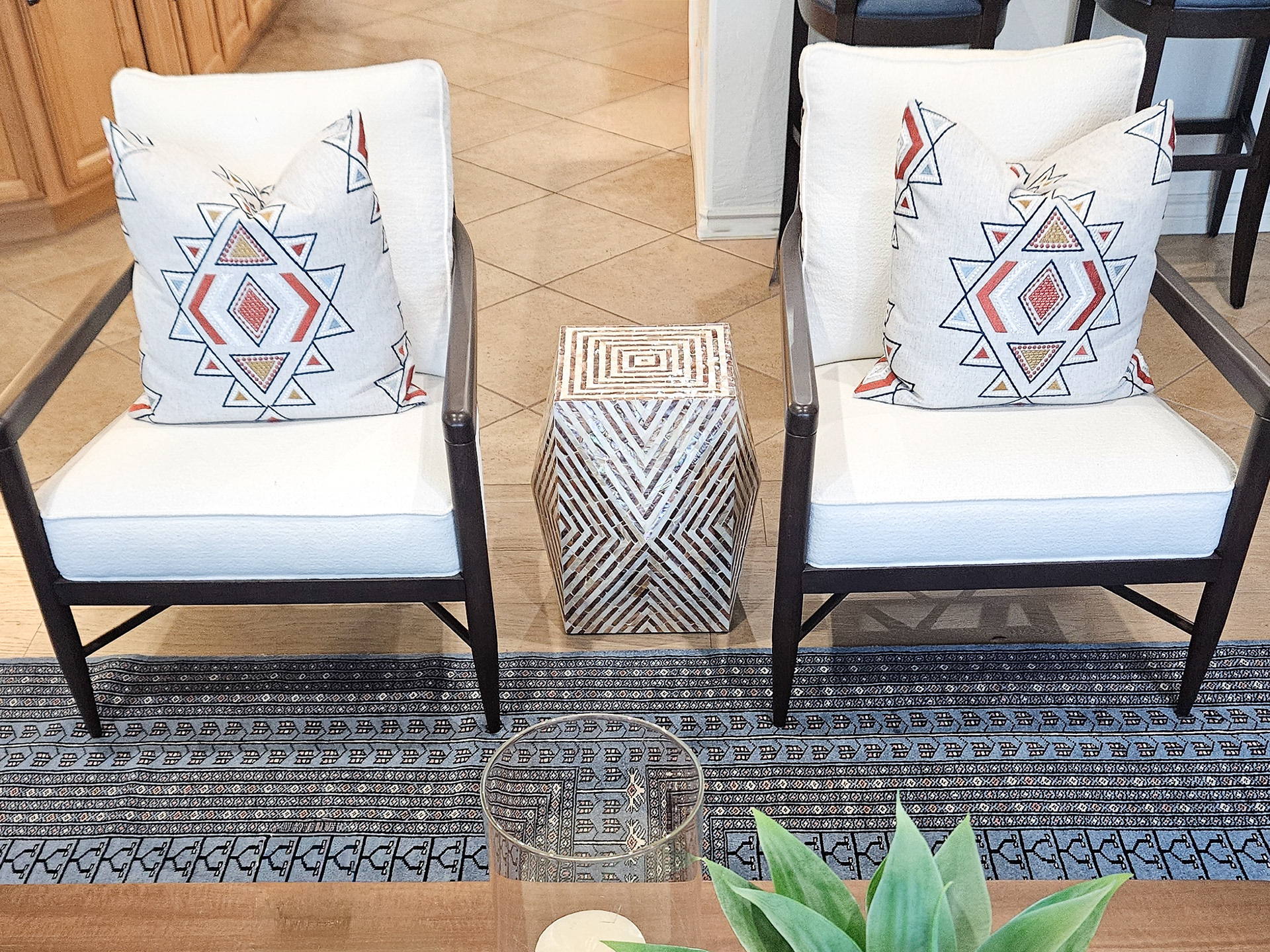 Geometric repetition and cultural influence meet architectural clarity in this curated seating arrangement.