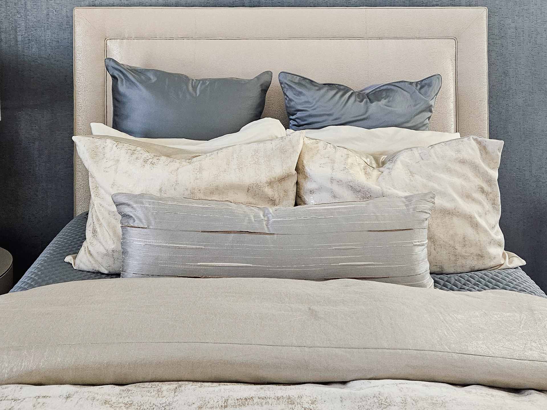 An intentional layering of champagne silks and cool mist-blue accents, curated to capture shifting natural light.