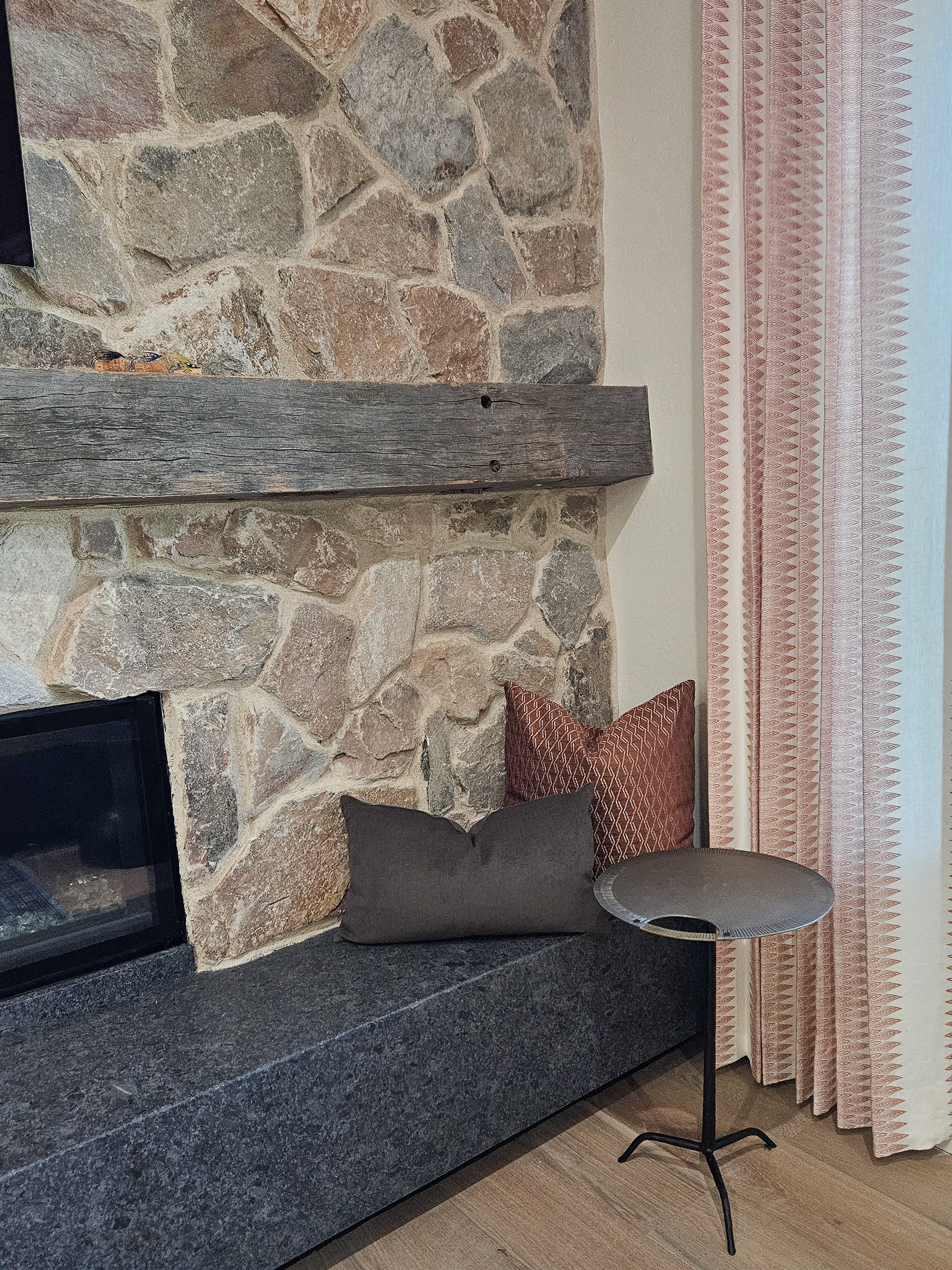 A study in raw, organic masonry and reclaimed timber, balanced by the delicate pattern of full length linen drapery.