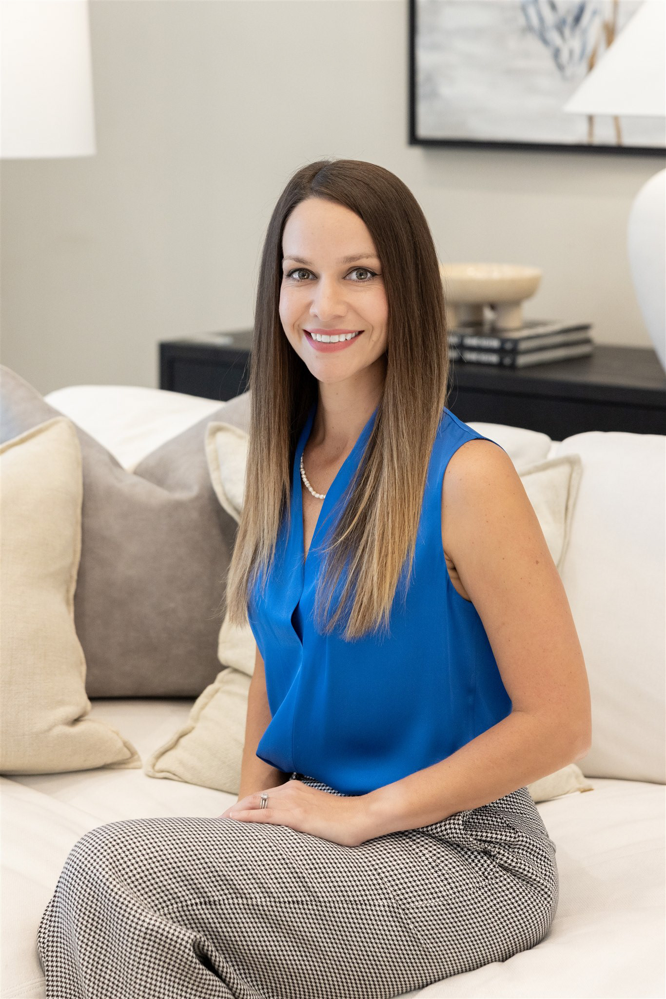 Elizabeth Brown, ASID Allied Interior Designer in Panama City, Florida, sitting in a professionally designed residential living space.