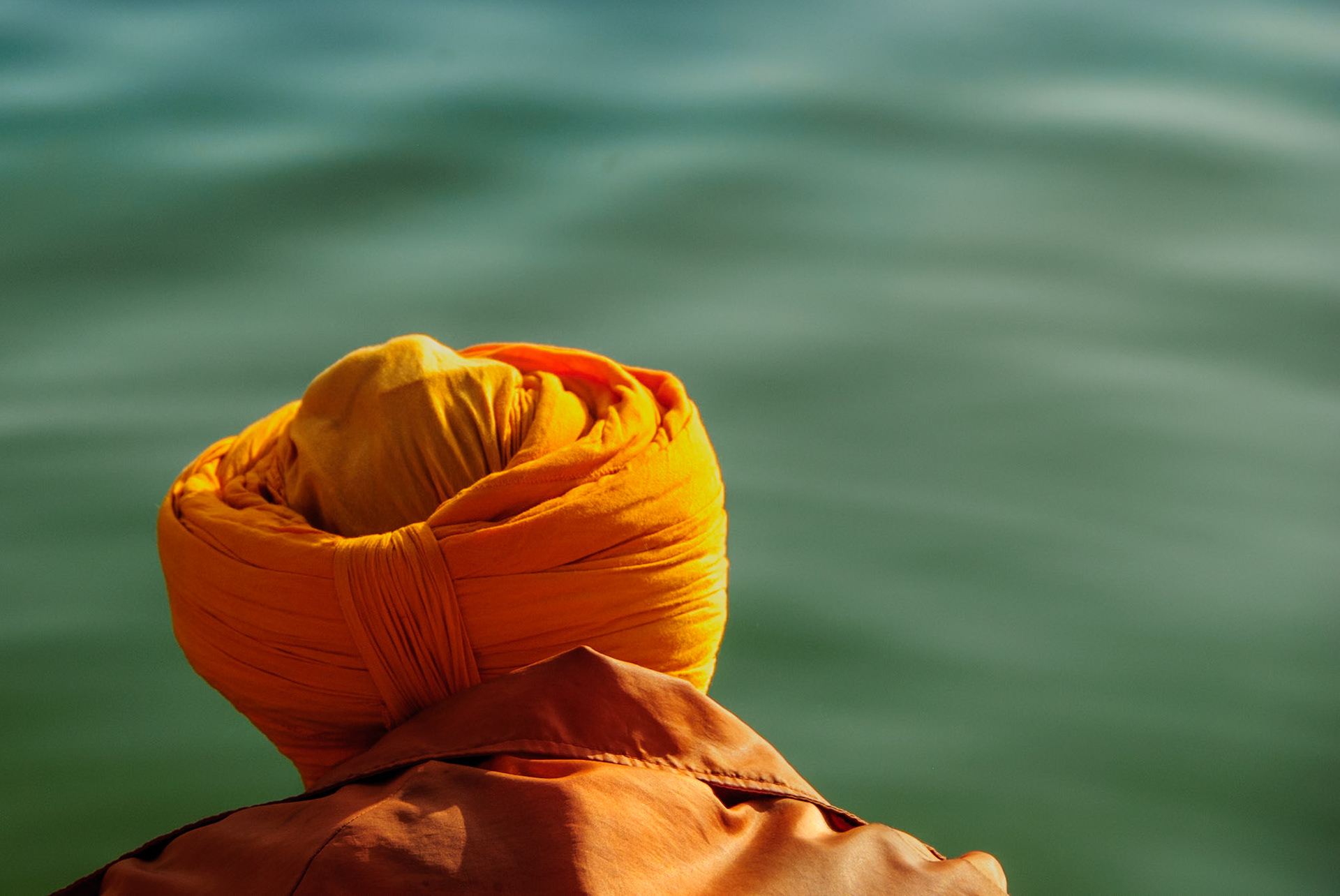Sikh man looking at holy water in Bangla Sahib Temple, New Delhi