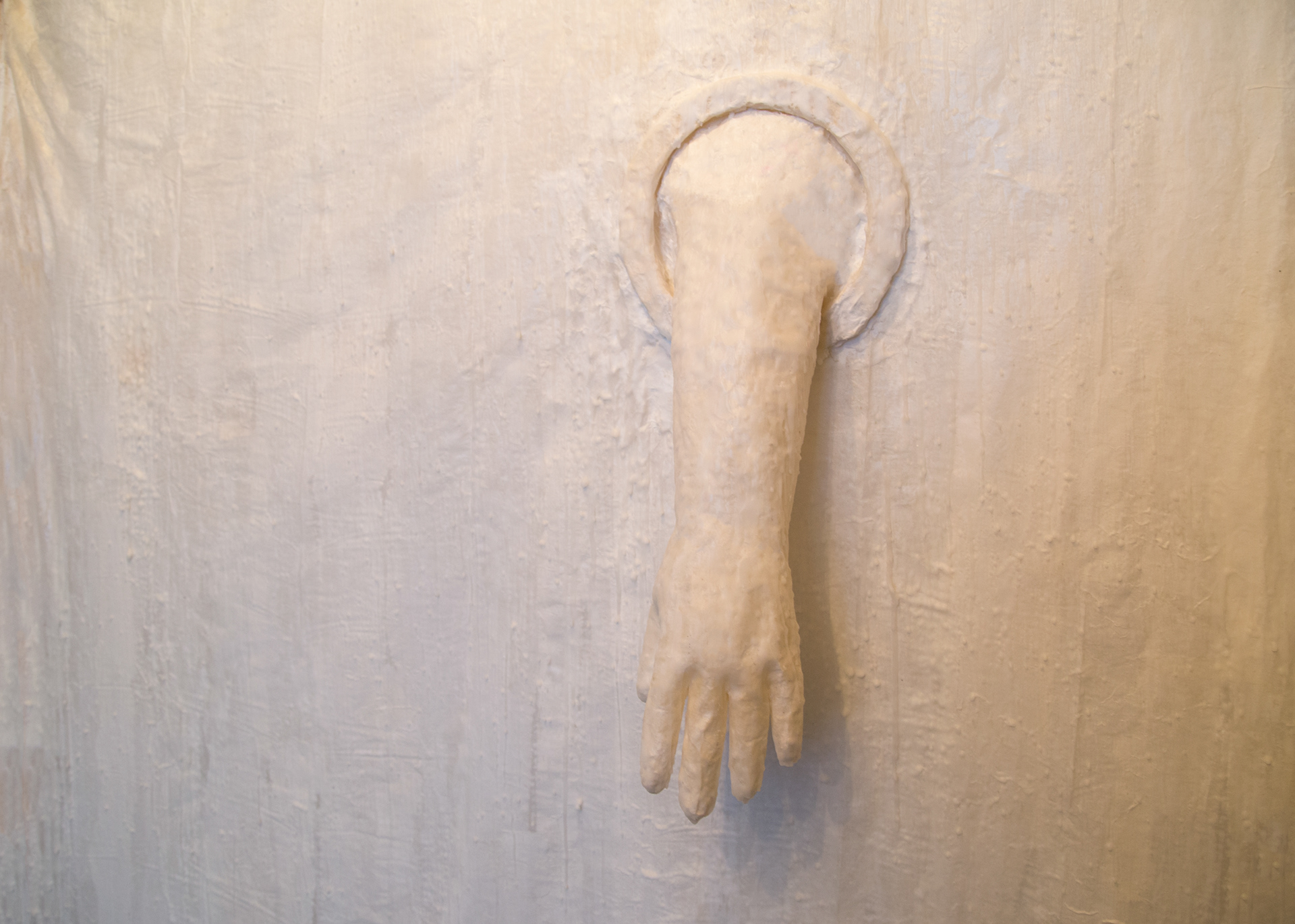 Detail of paper and wax membrane / wall structure with a paper and wax quarantine glove pushing through.
