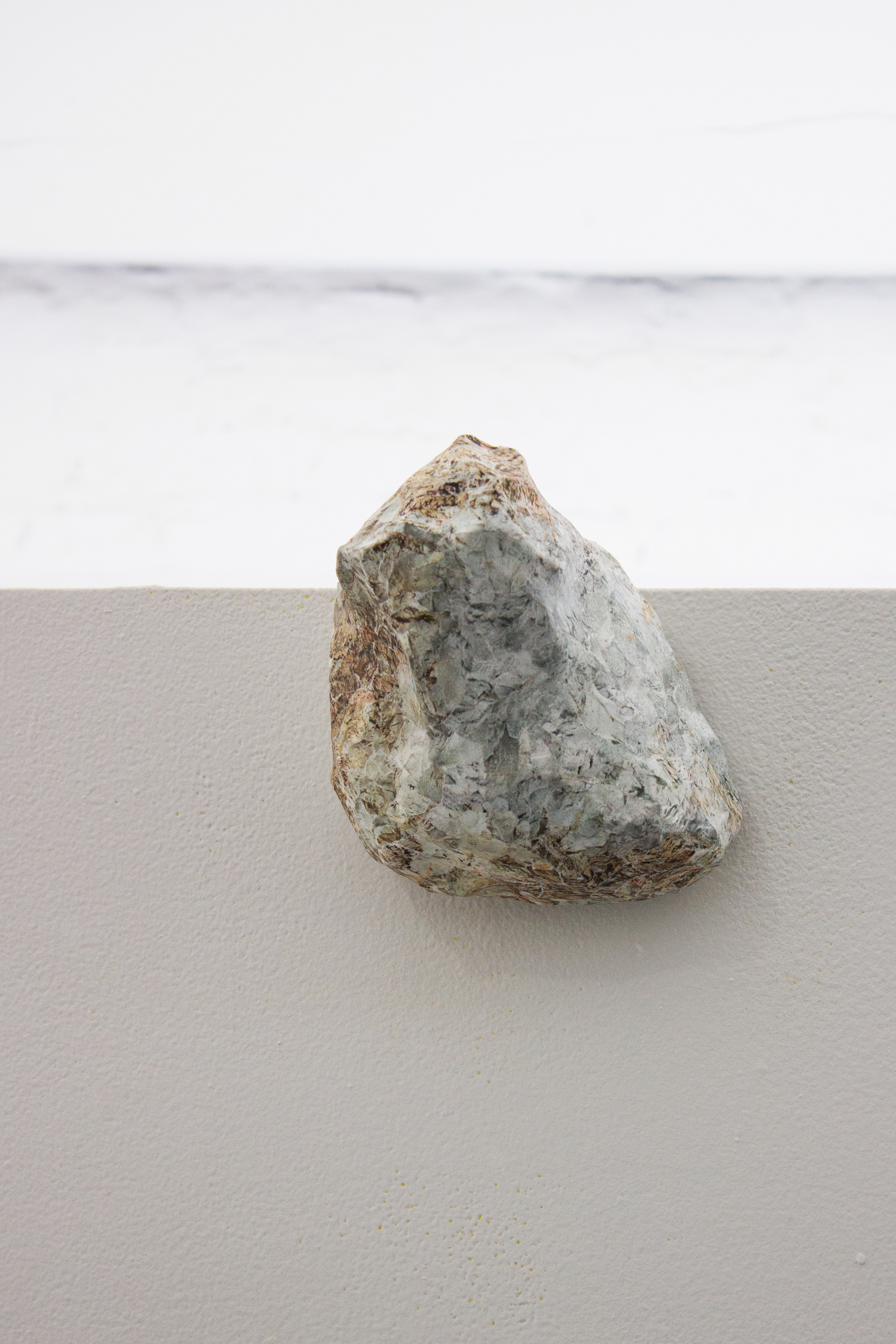 "Their Natural State" closeup of Rubble sculpture hanging at the top center edge of the gallery's freestanding wall.