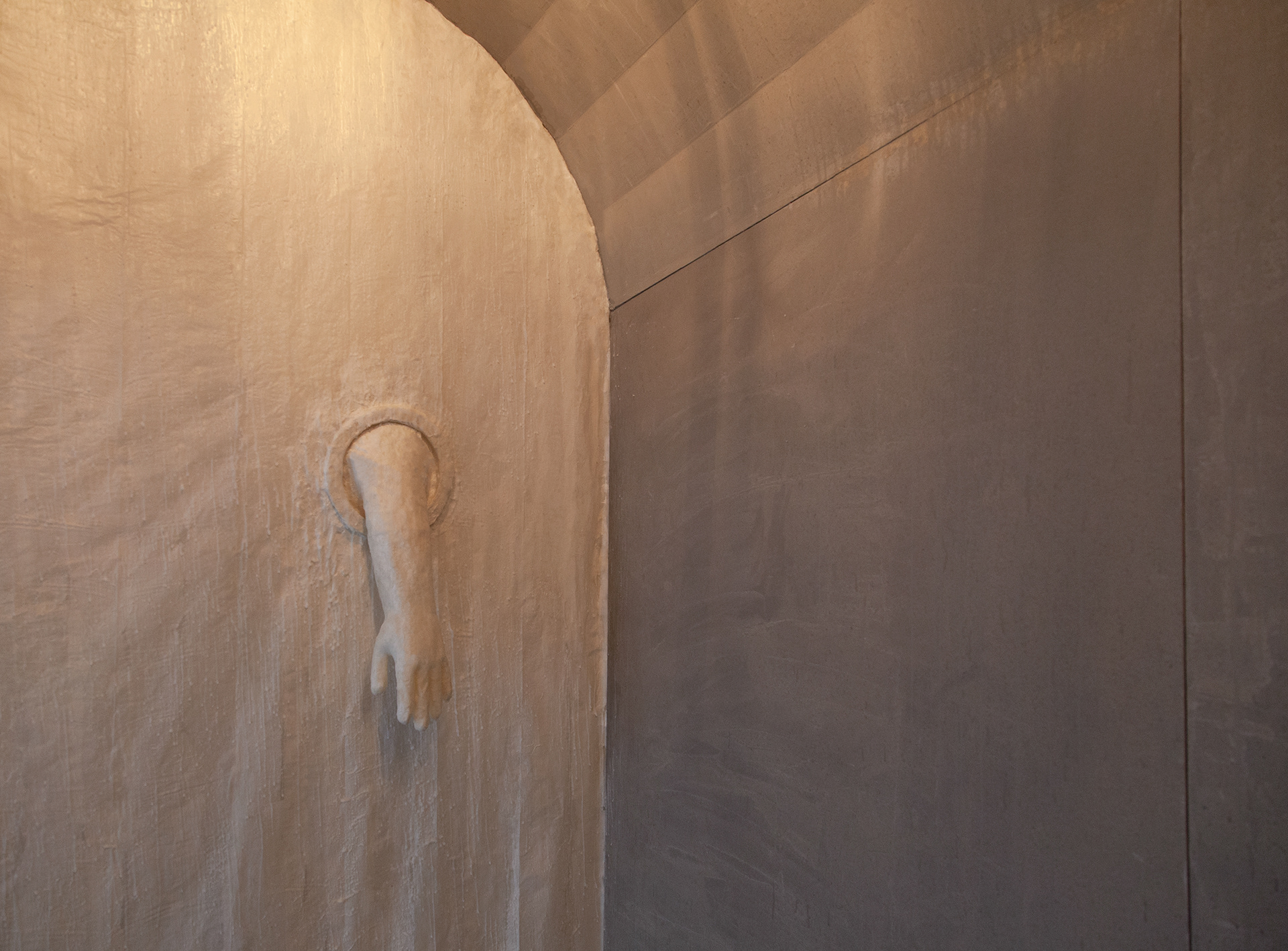 Angled detail of paper and wax membrane / wall structure with a paper and wax quarantine glove pushing through.
