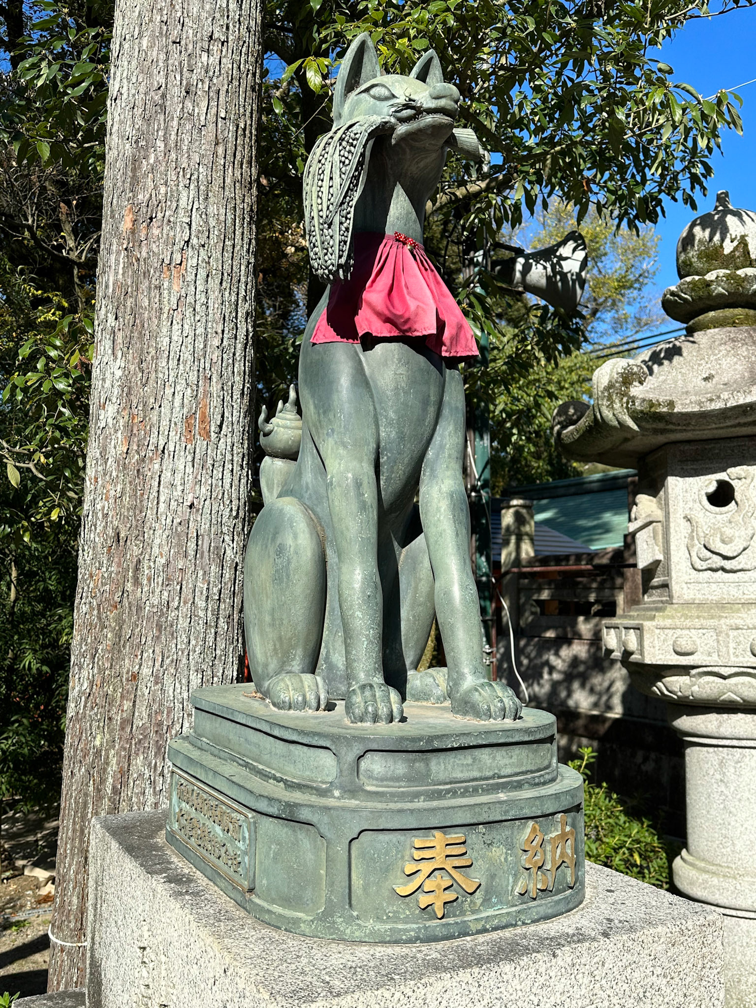 One of the many stone fox statues which are known as Inari foxes or kitsune.