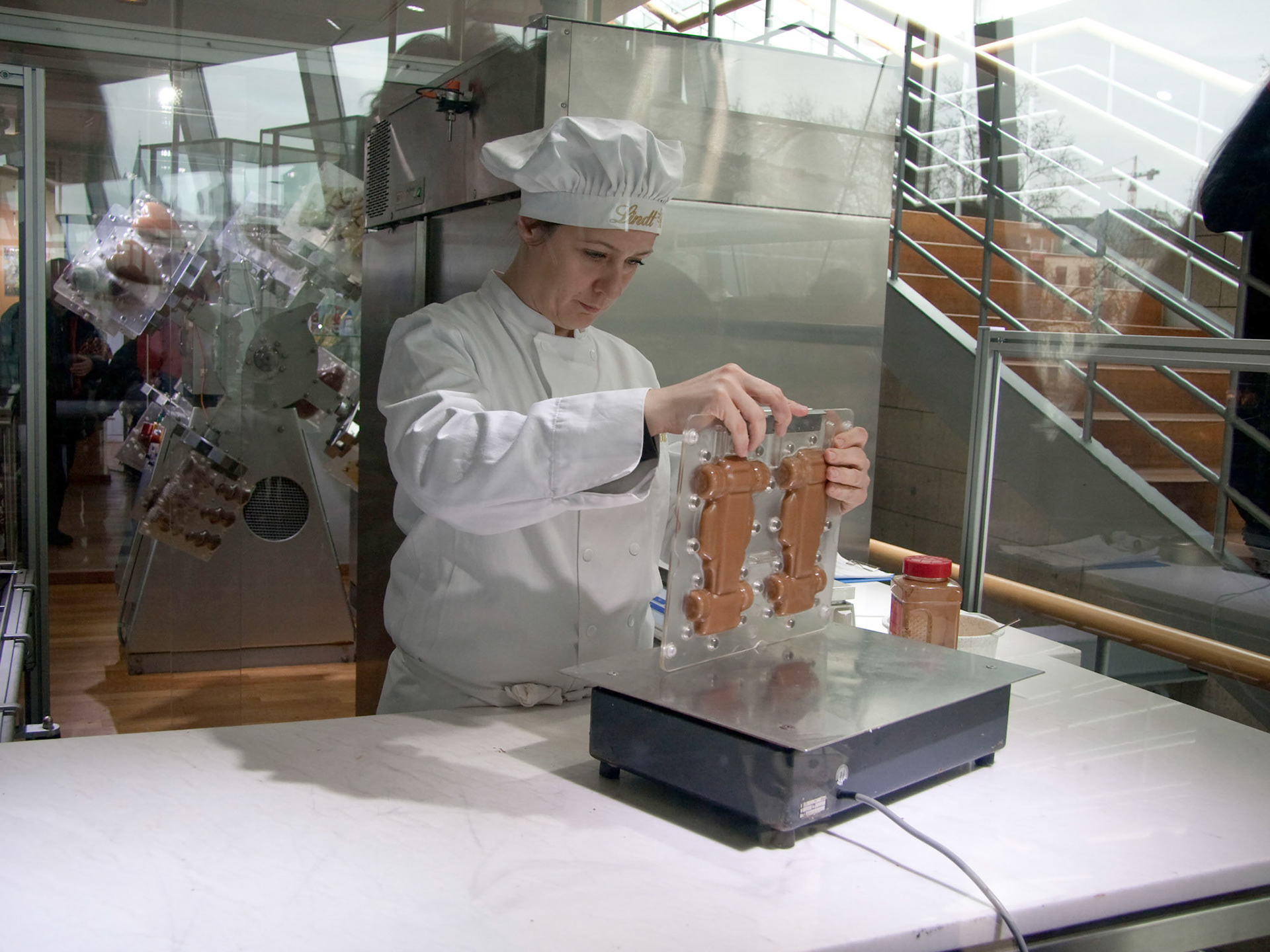 The vibrating plate distributes the chocolate evenly around the mold