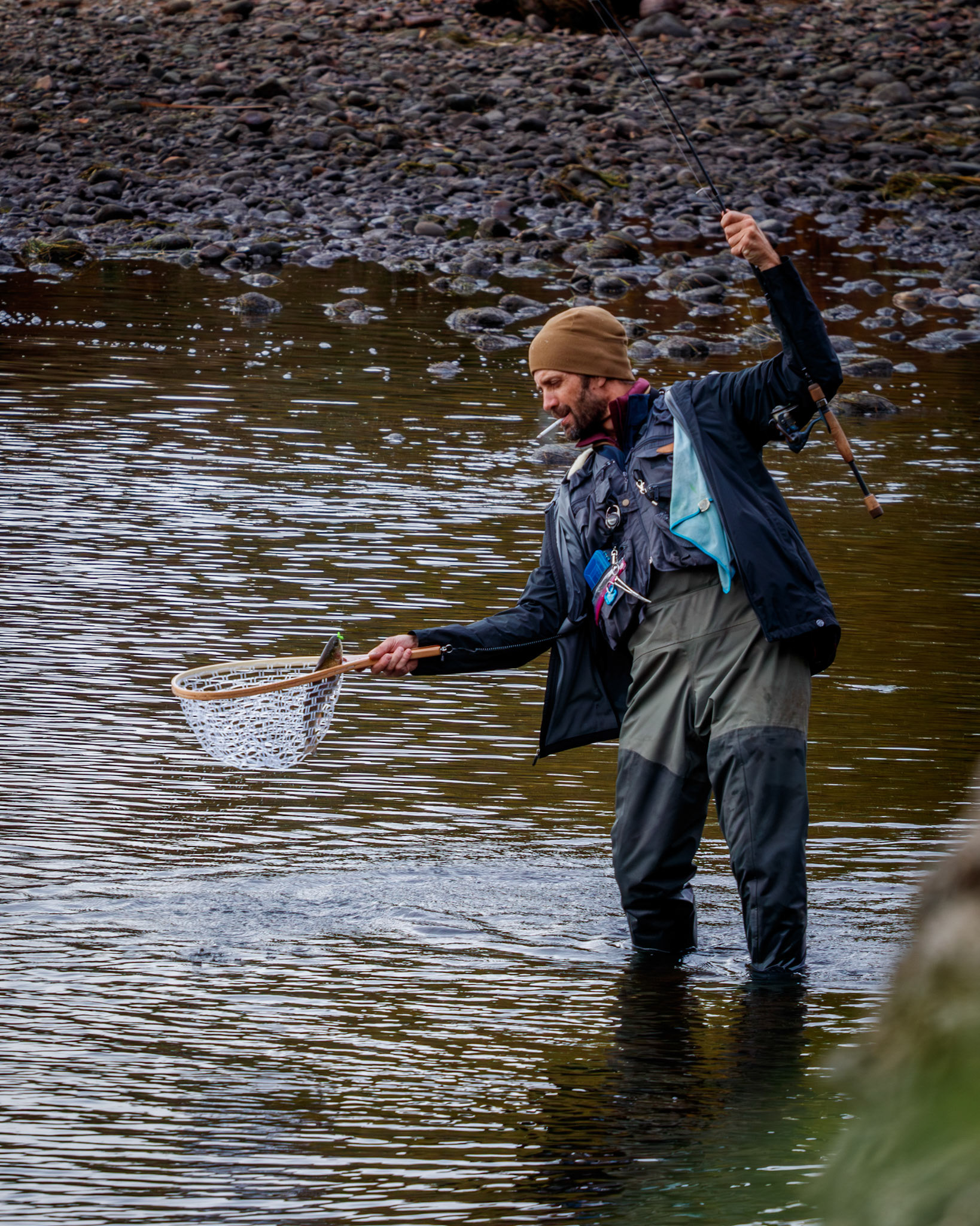 Catching a trout from the salt river without even putting out his cigarette