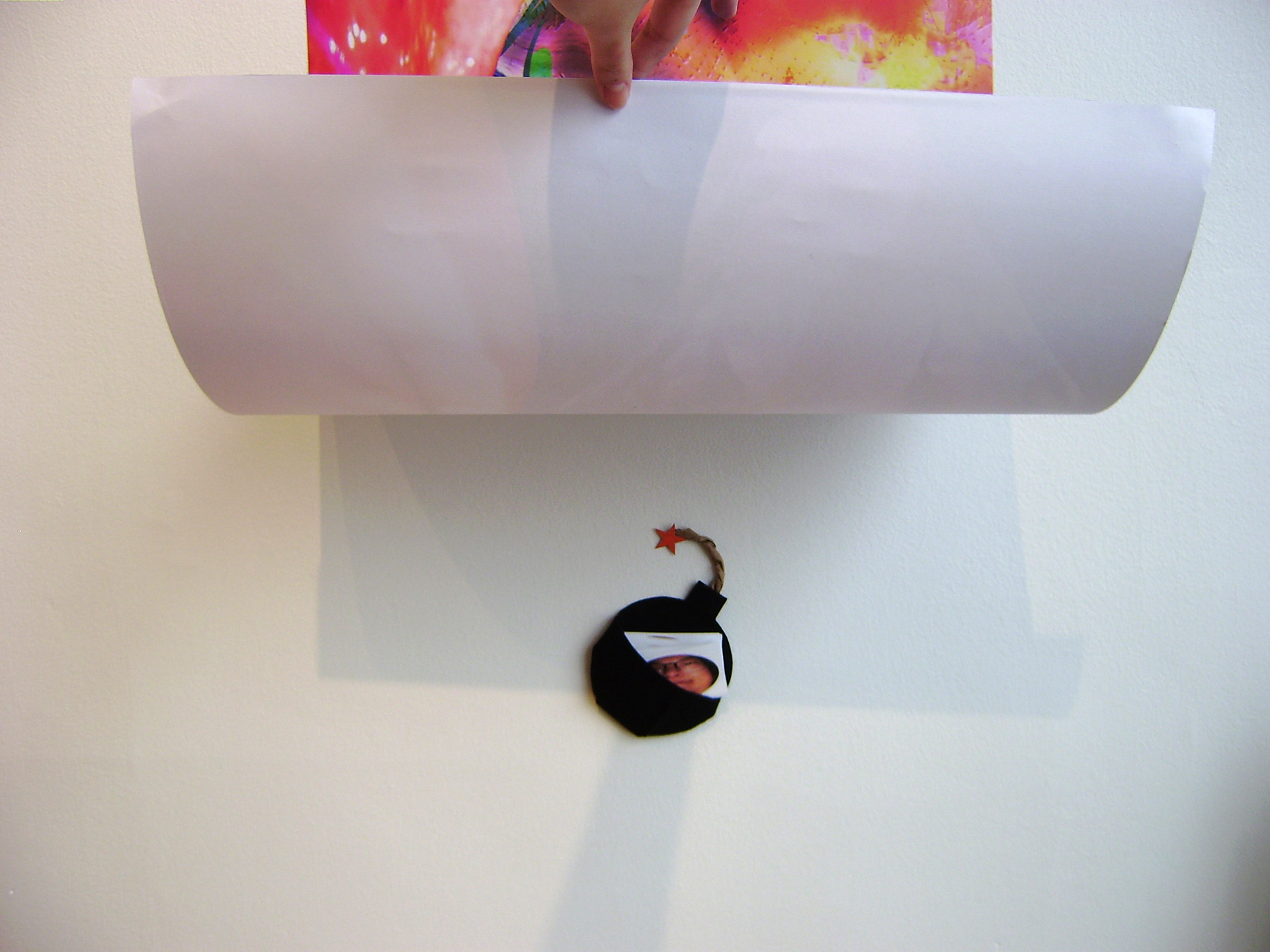 bomb holder with stickers of my face found underneath the poster