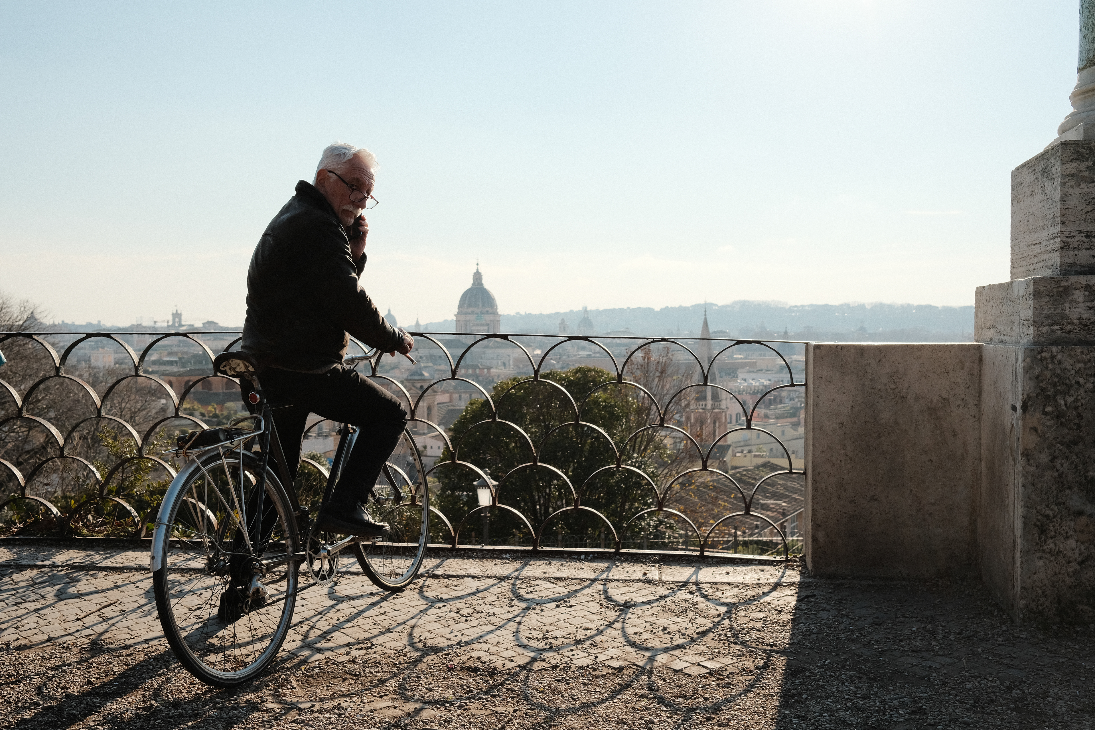 Man on a bicycle at a vantage point. Rome, Italy 2024.