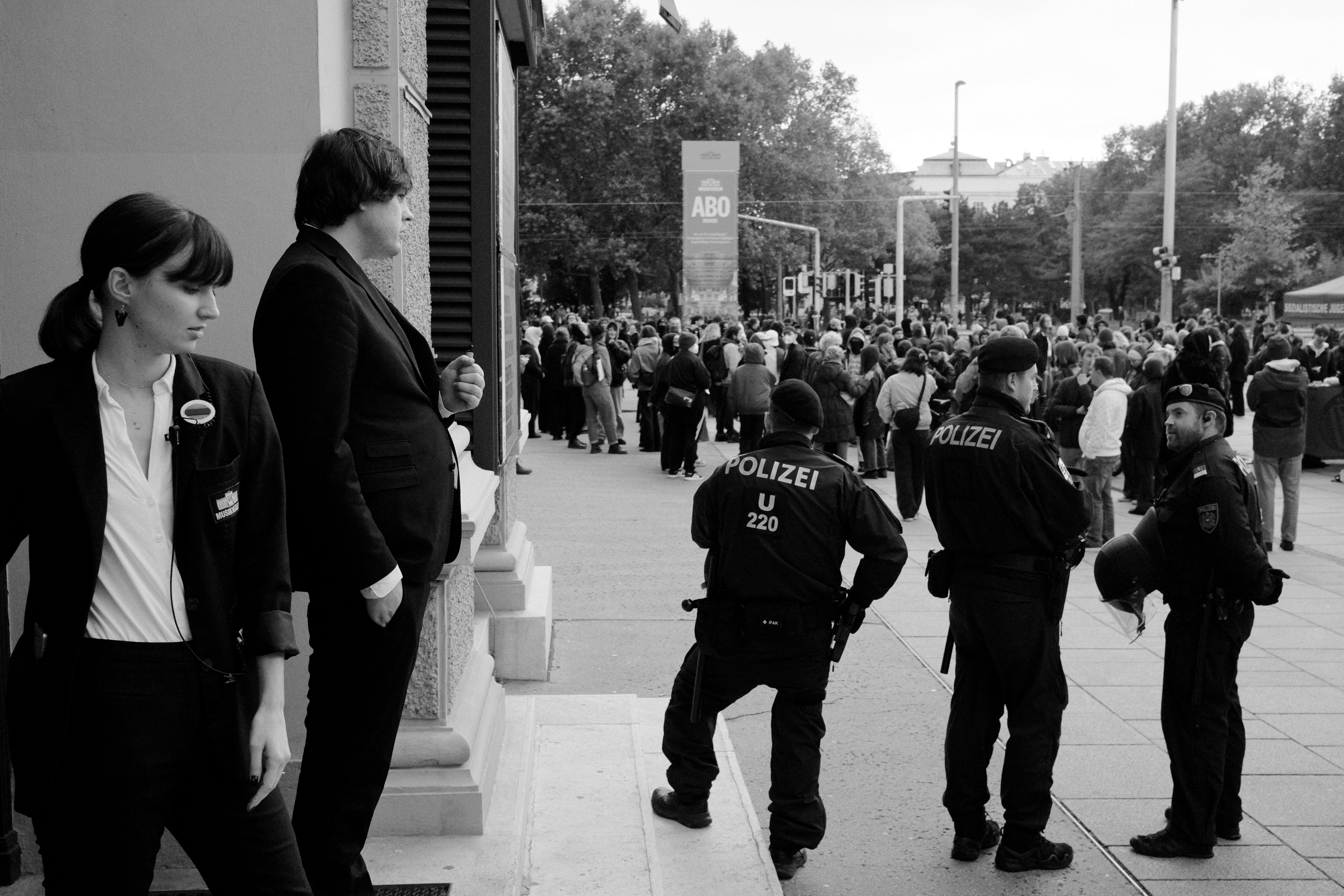 Musikverein staff observing police and protesters. Vienna, Austria 2024.