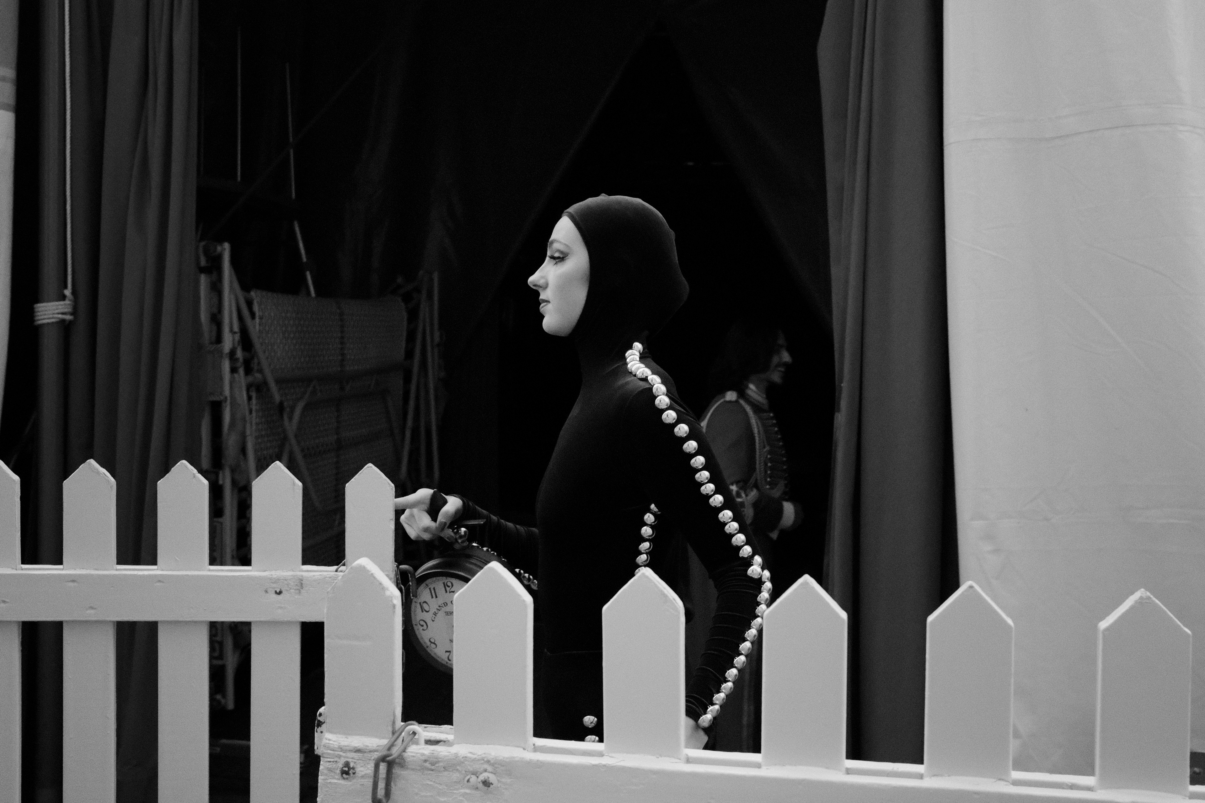 Lady carrying a clock. Vienna, Austria 2024.