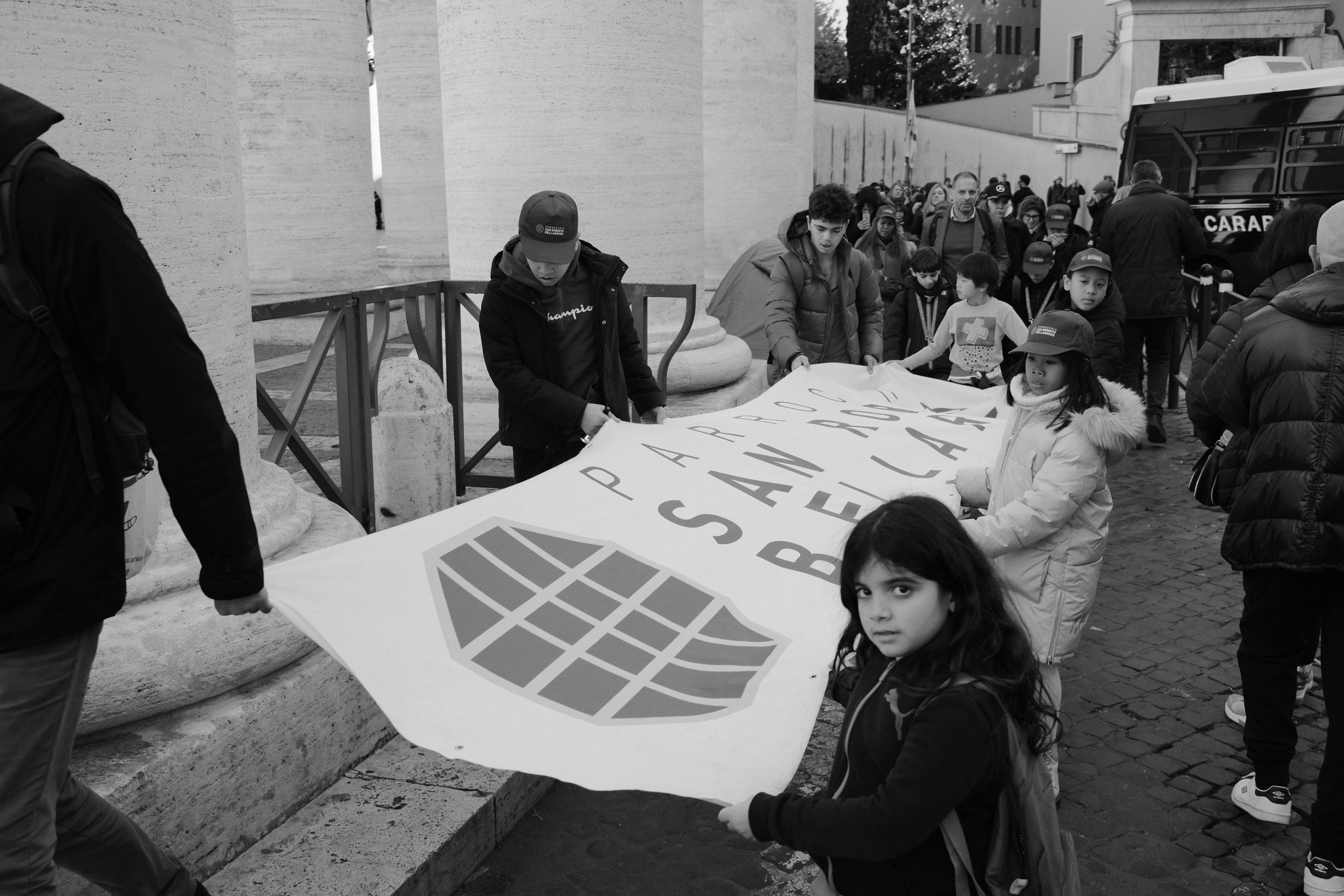 Children carrying a poster. Piazza San Pietro, Vatican City 2024.