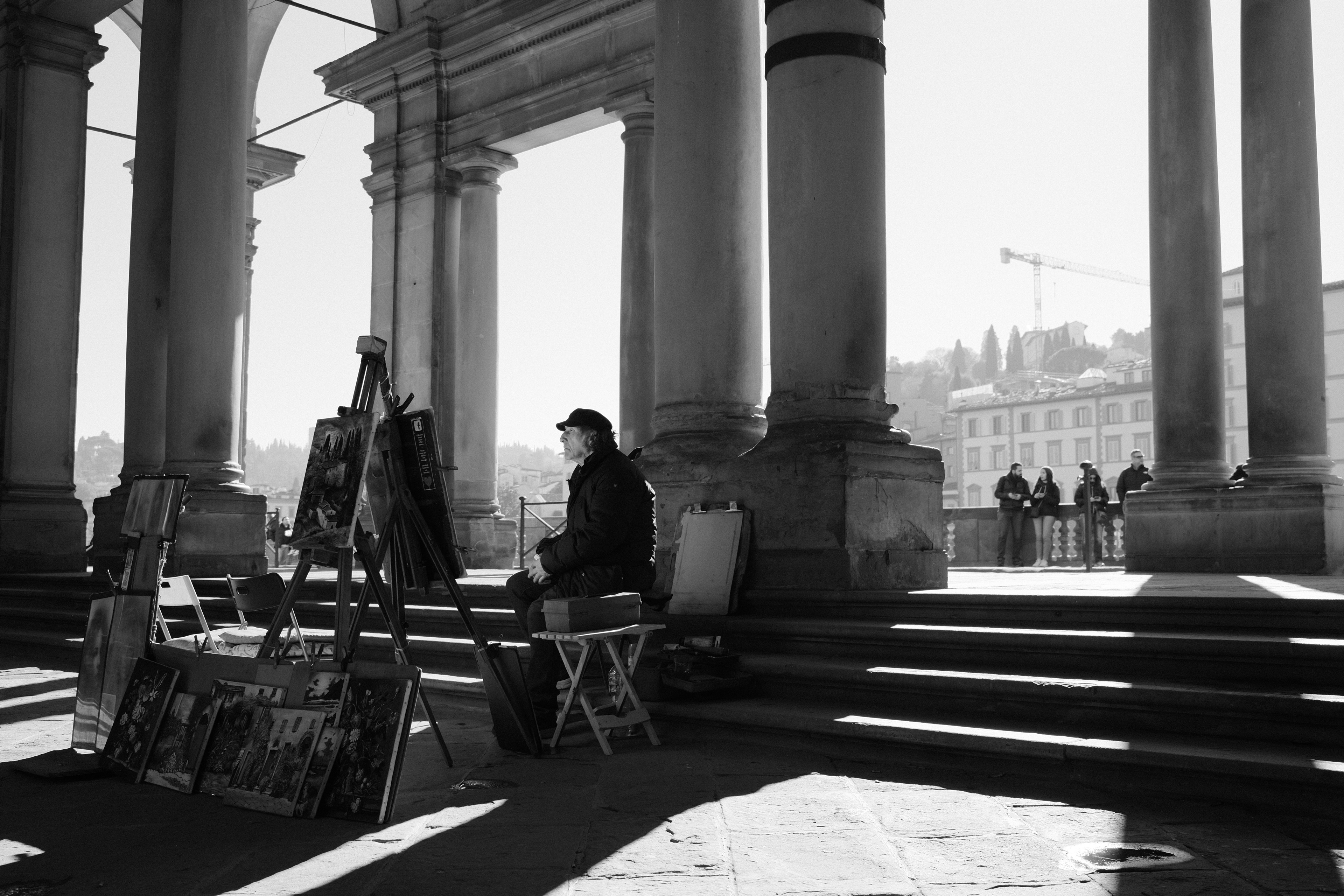 Painter waiting for customers. Florence, Italy 2024.