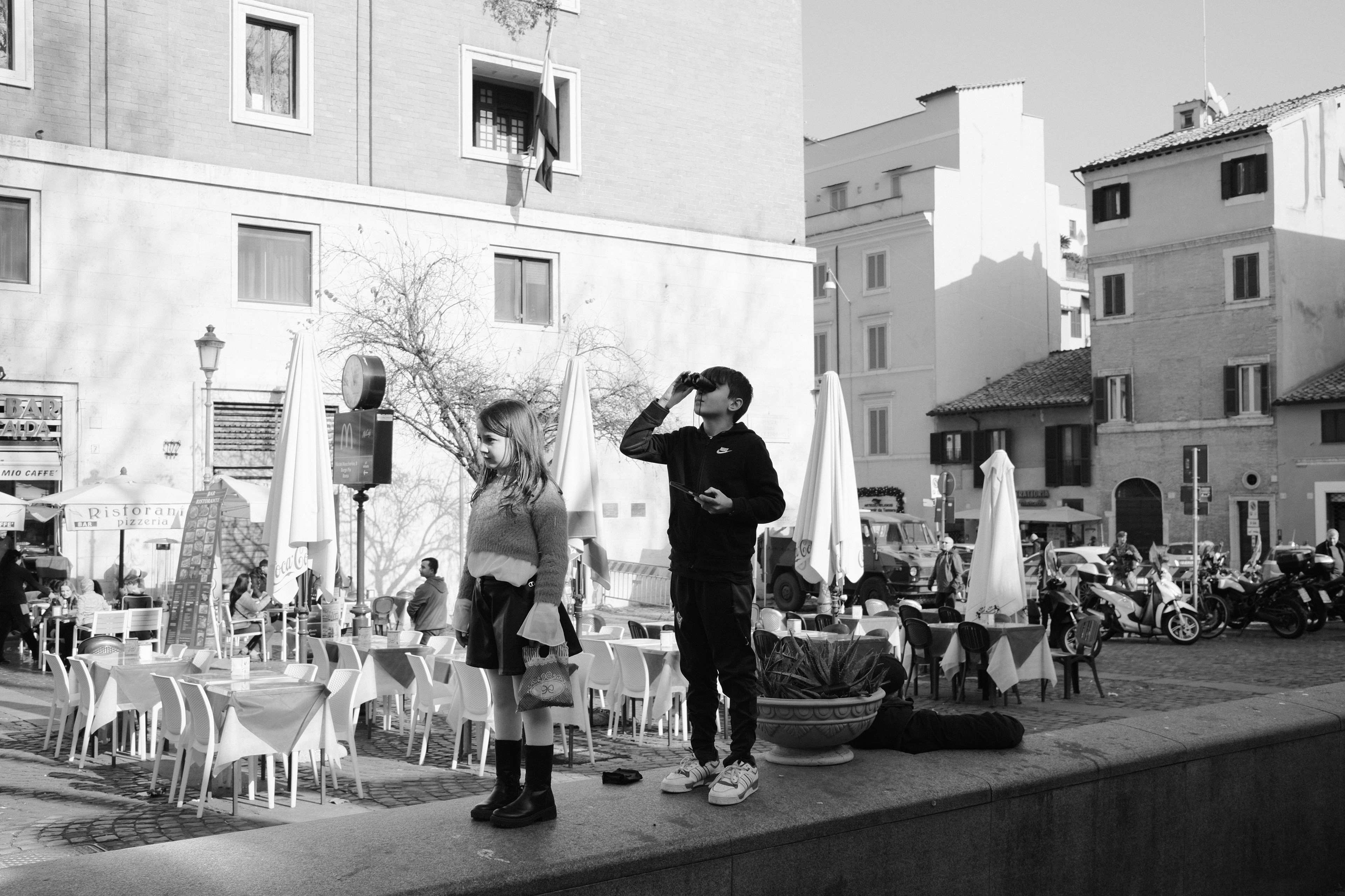 Young boy with binoculars watching Pope Francis. Rome, Italy 2024.