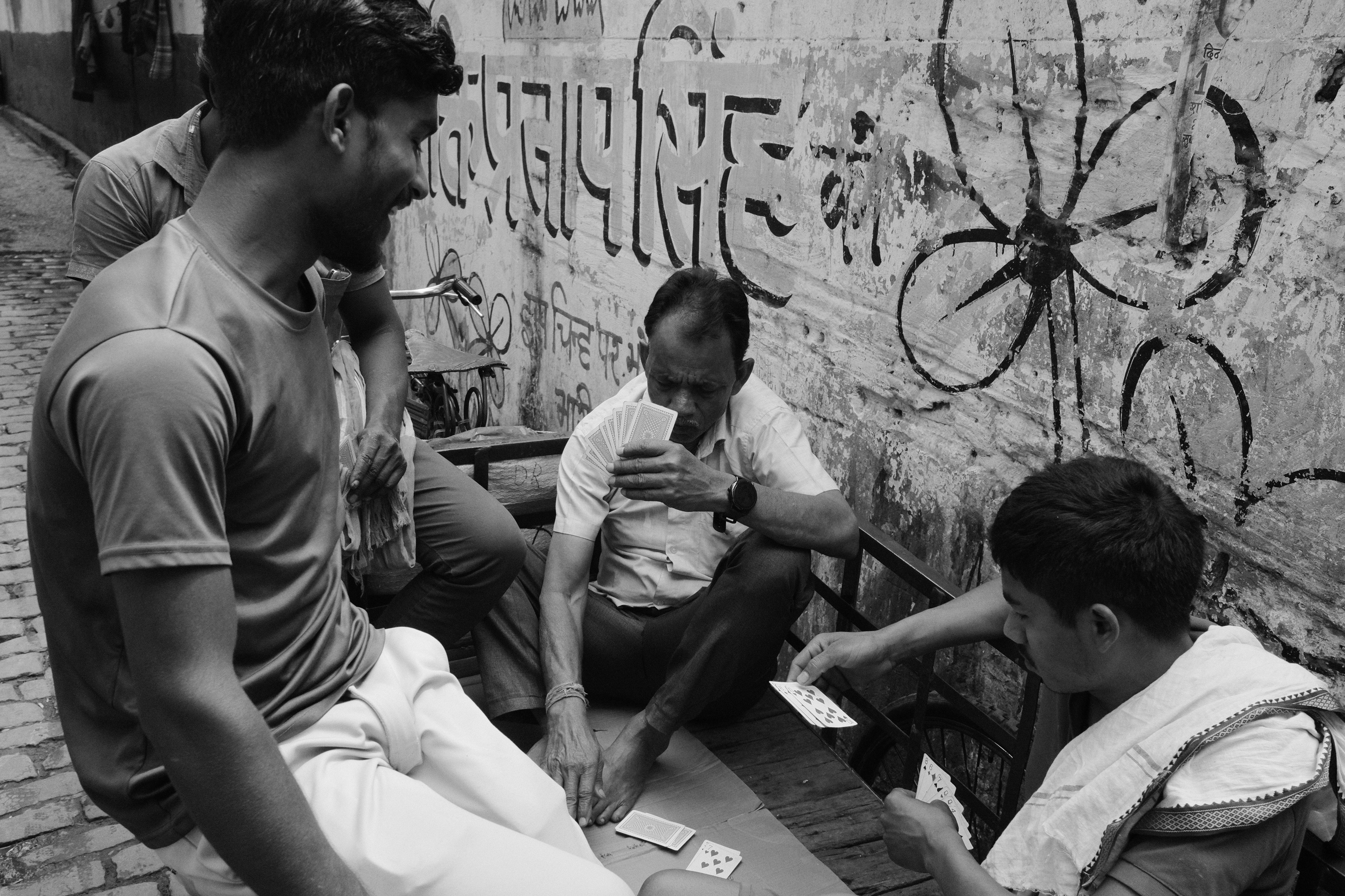 People playing cards in the street. Calcutta, India 2024.