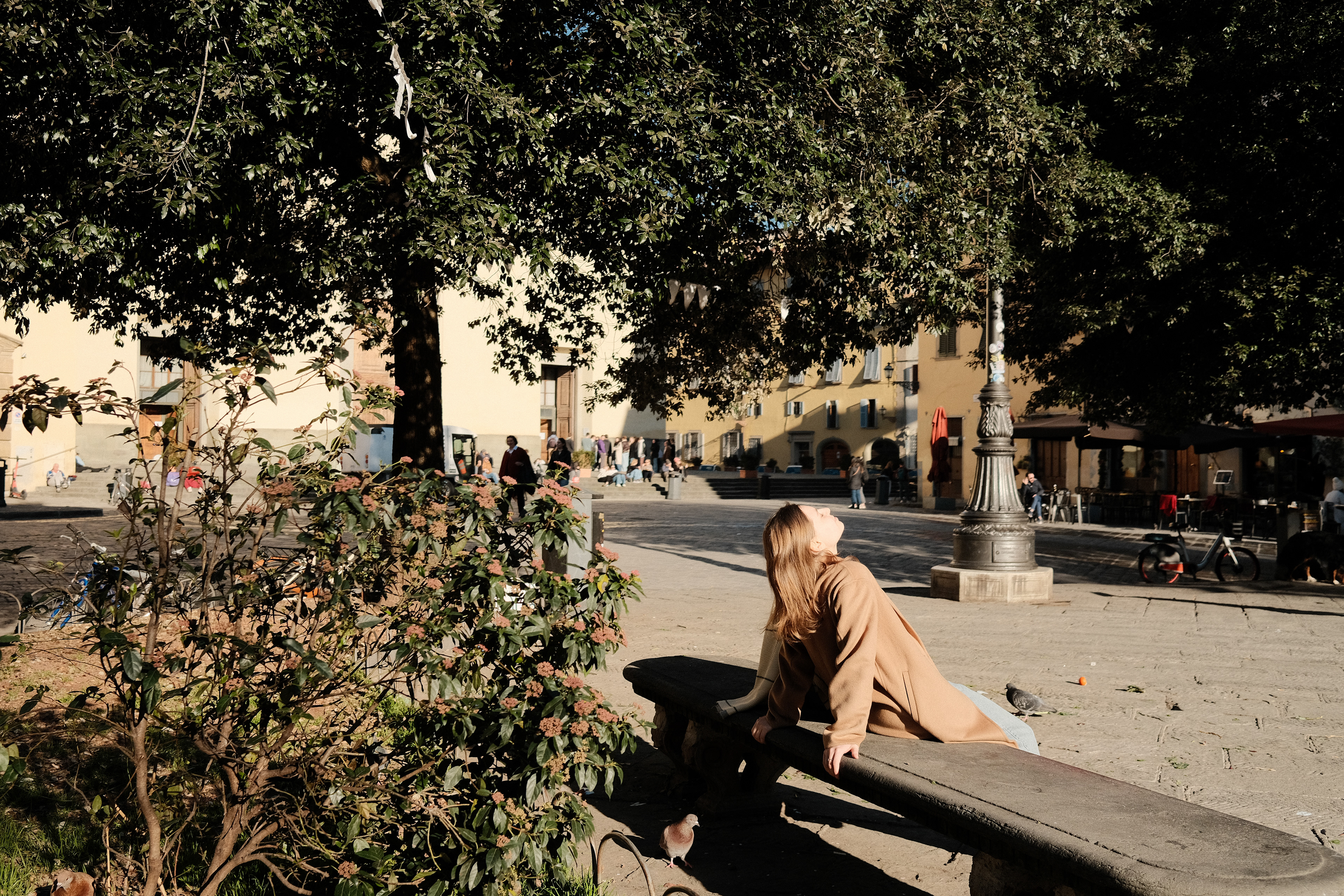 A woman enjoying the winter sun. Florence, Italy 2024.
