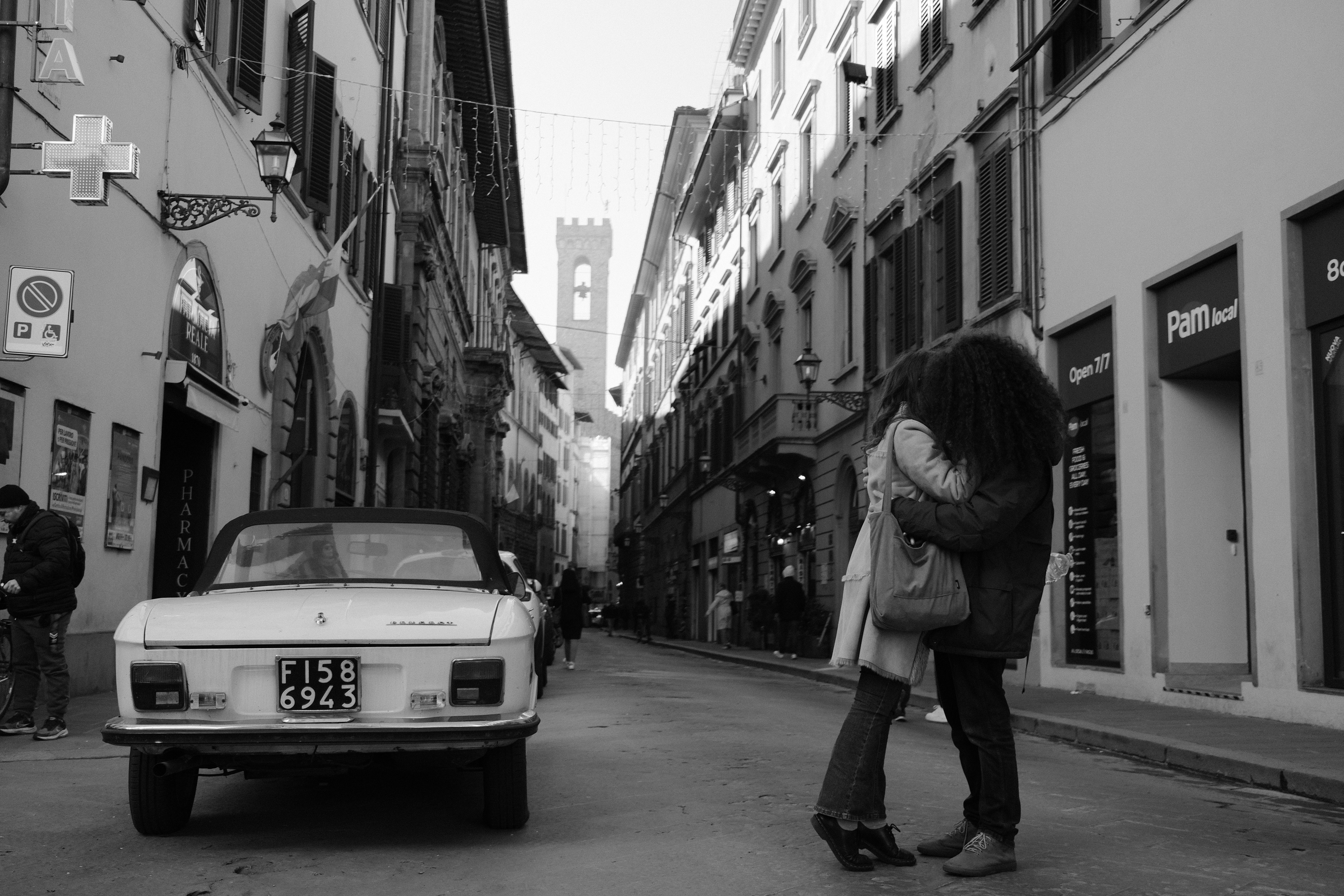 A couple kissing with the Palazzo del Bargello in the background. Florence, Italy 2024.