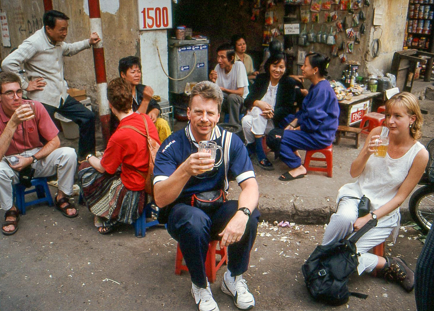 Sitting on tiny stools enjoying a very cheap beer