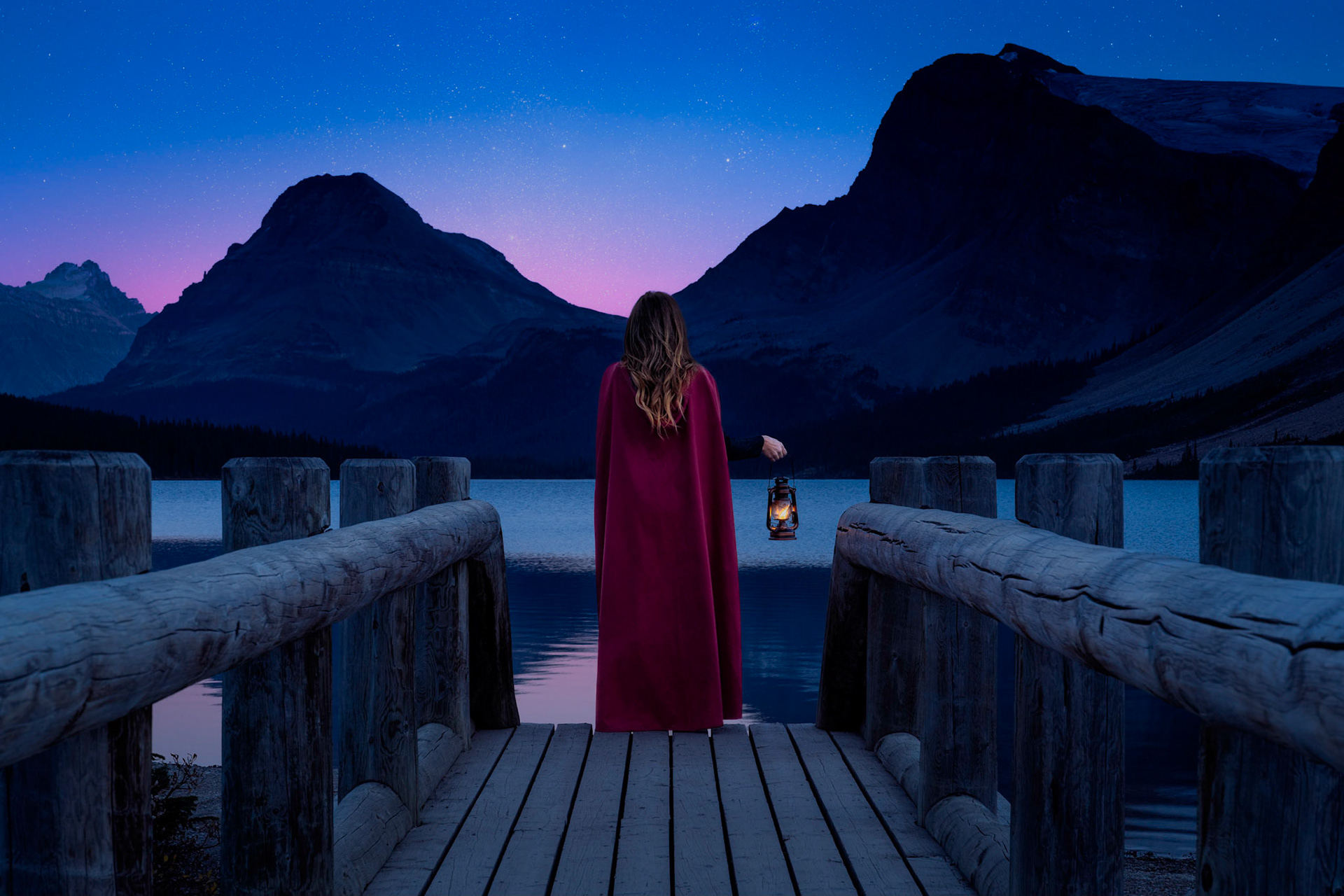 As day surrenders to night, the sky reveals its deepest shades of blue. Slowly, the stars emerge and begin to cast a soft, magical glow across the landscape. She stands perfectly still, completely immersed in the beauty and tranquility of nature's masterpiece.