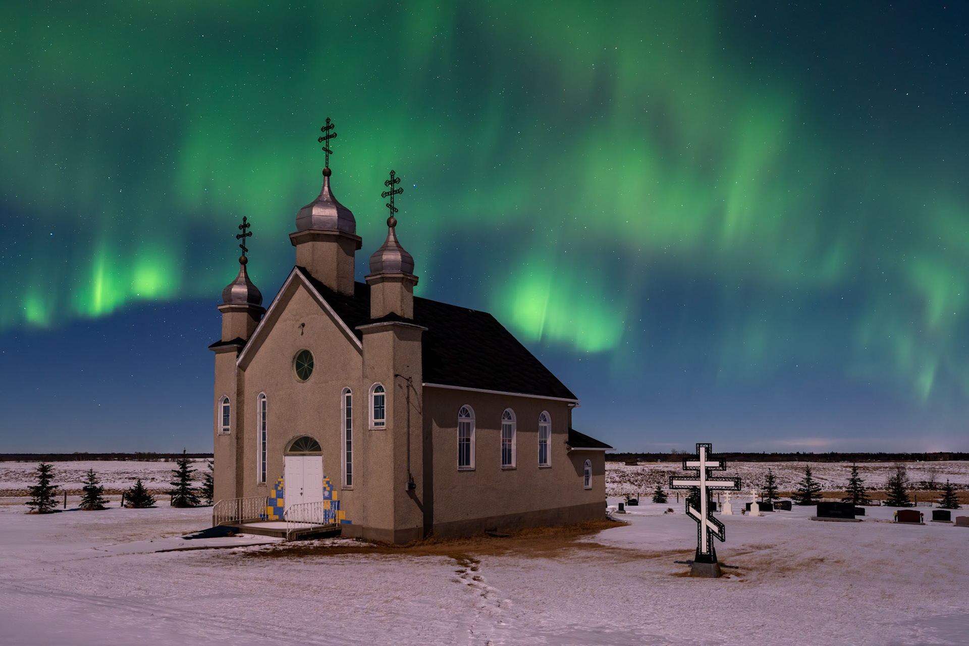 Aurora dances above a church in rural Alberta.