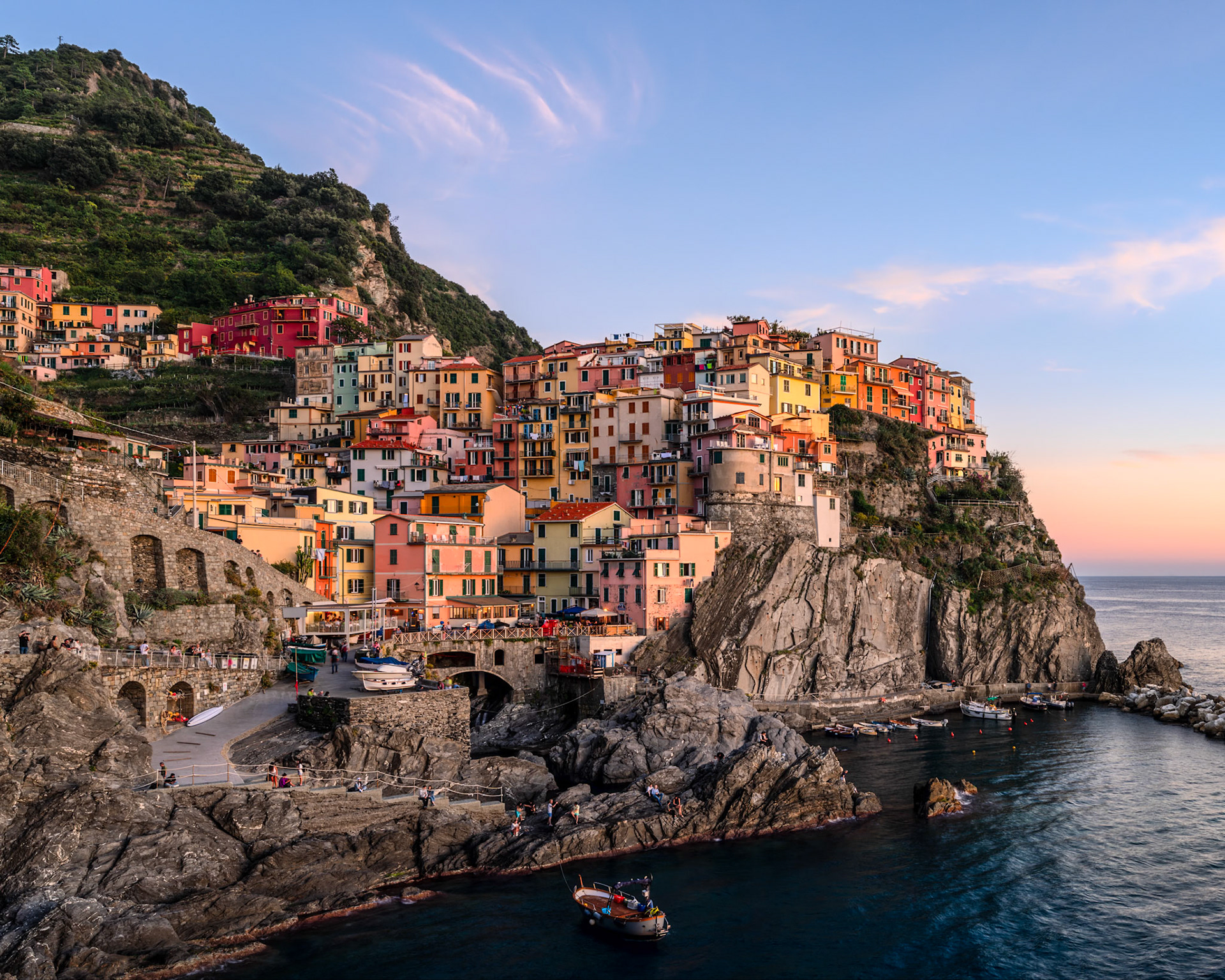 The setting sun casts golden light on the village of Manarola, in Cinque Terre.