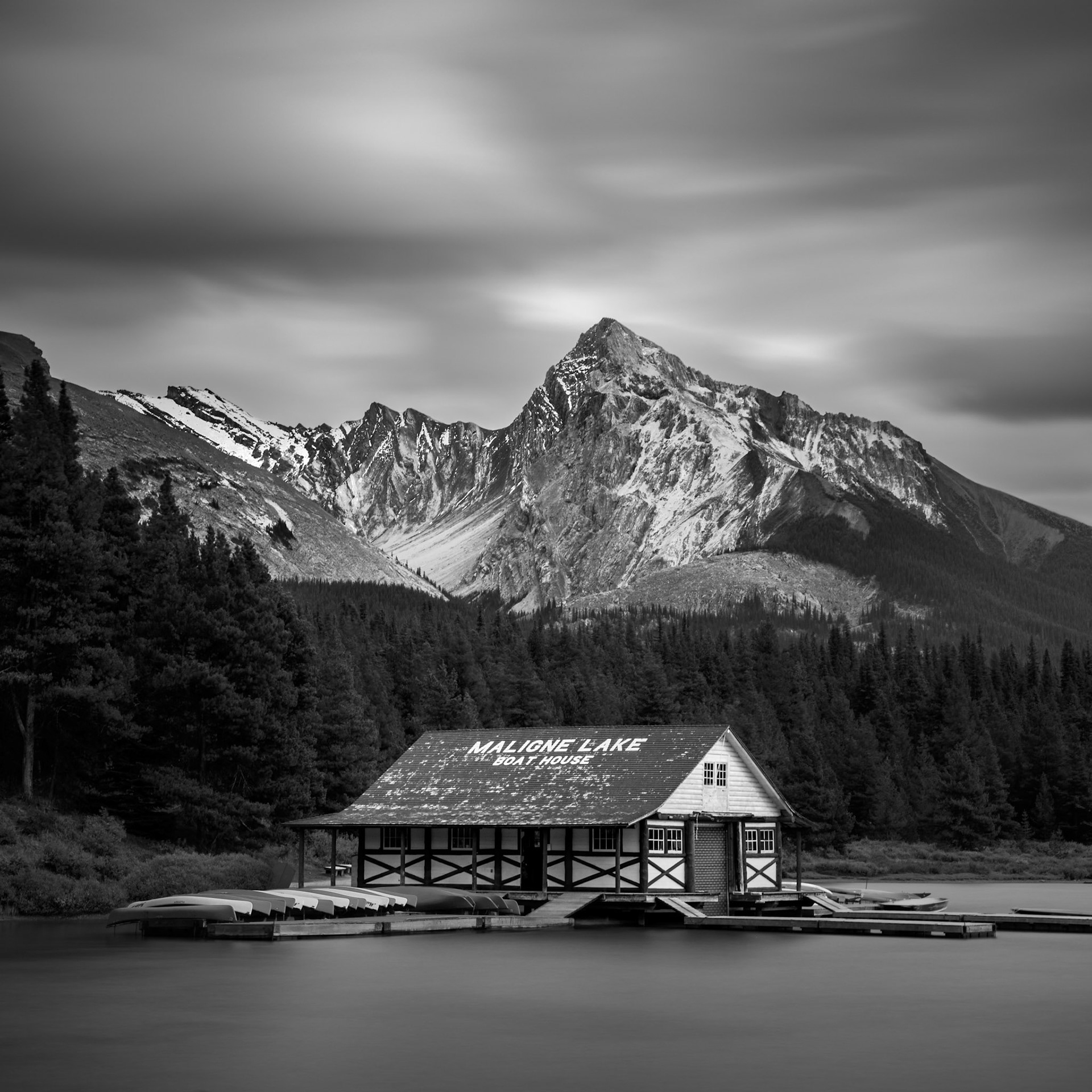 Storm clouds brewing above the boat house at Maligne Lake, in Jasper National Park, Alberta, Canada.