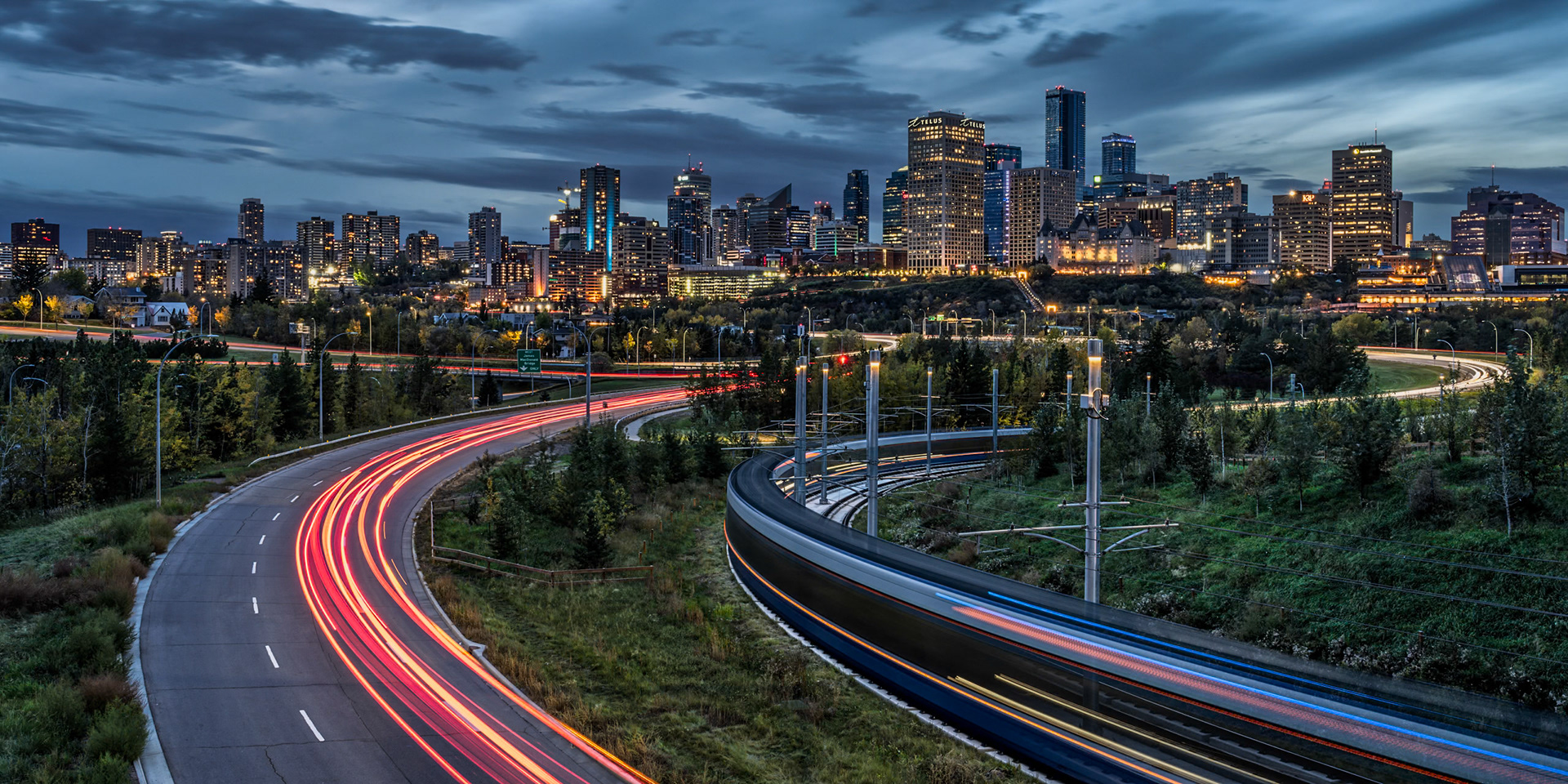 Light meets night as cars and a train weave in and out of downtown Edmonton.
