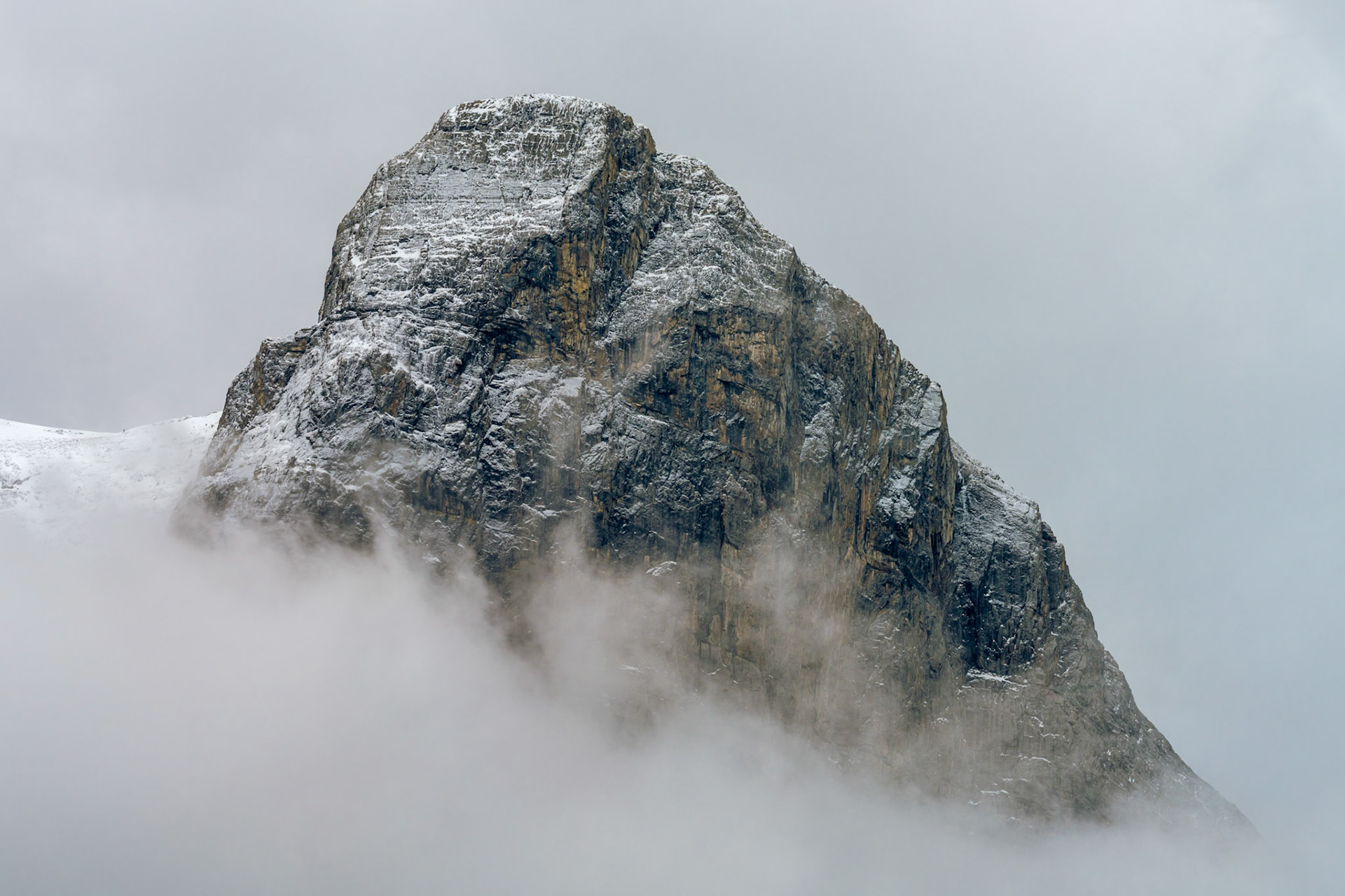 The top of Ha Ling Peak, near Canmore, Alberta, breaks through the morning clouds.
