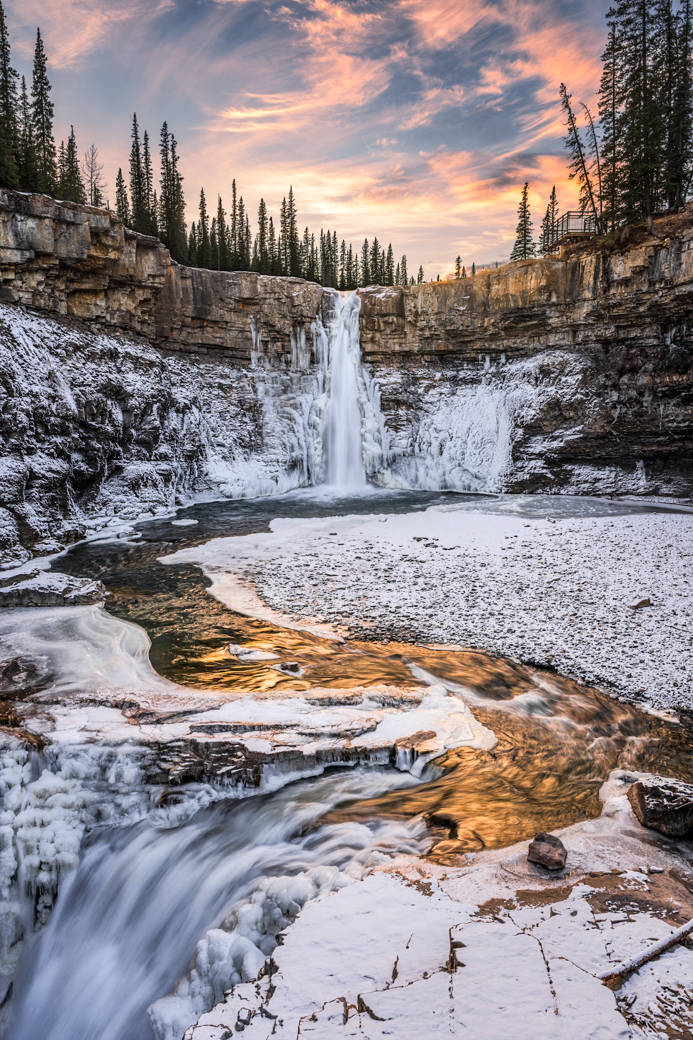 A spectacular sunset casts golden reflections on the ice cold water of Crescent Falls in early November.