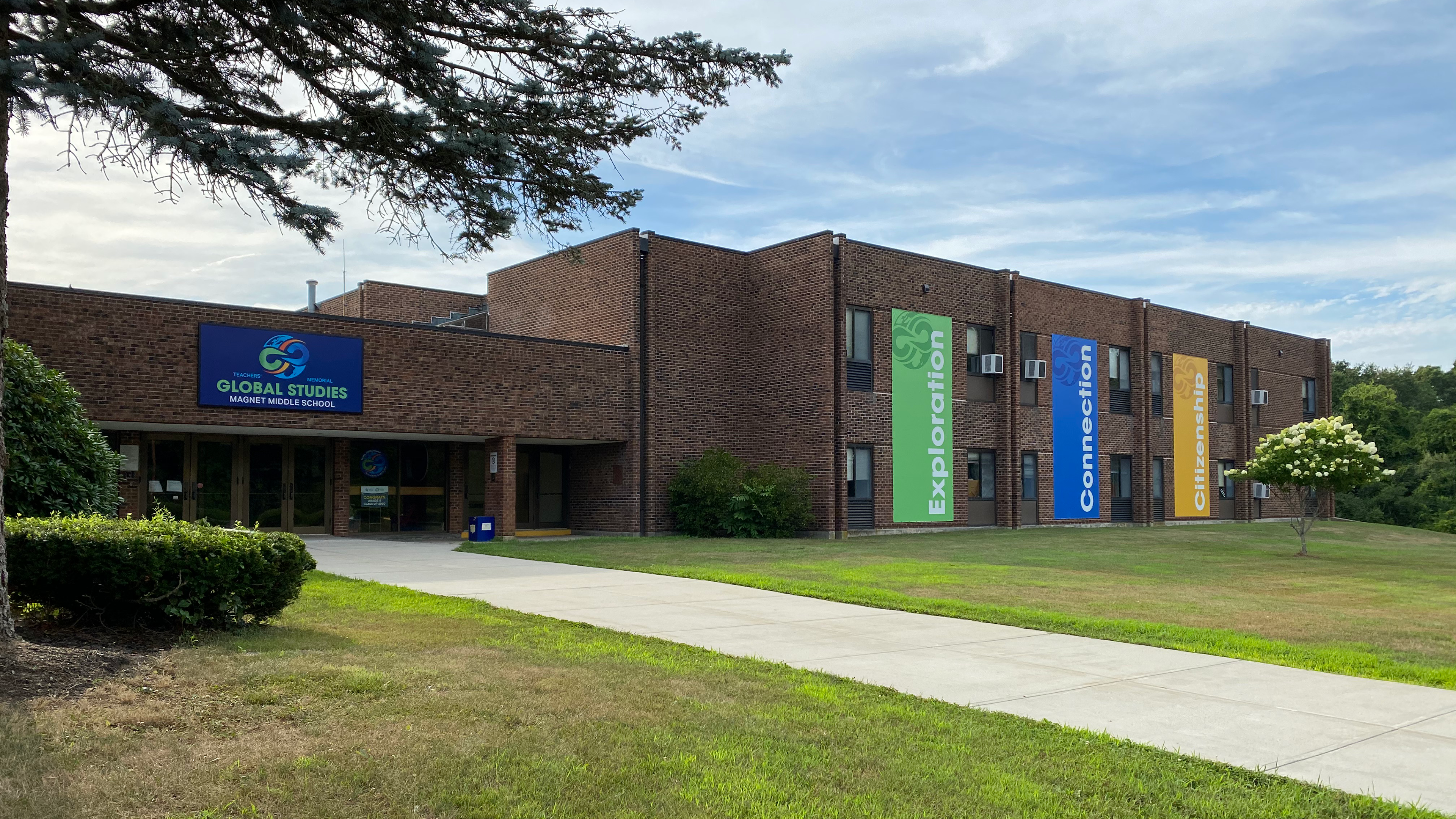 Front of school with large colorful signage.