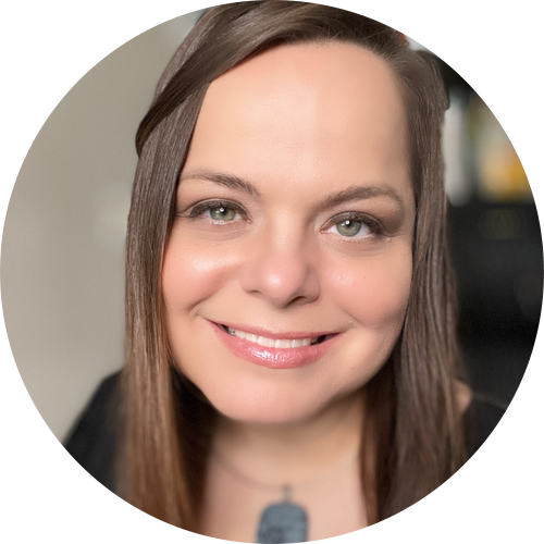 Woman smiling with a necklace.