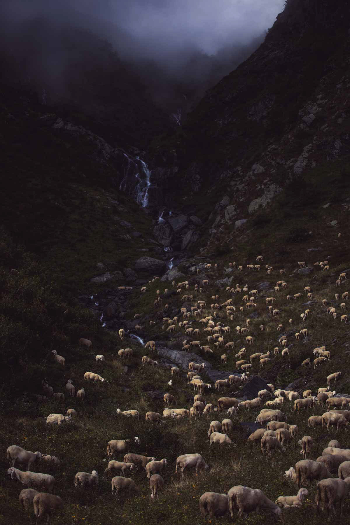 Storm is coming - clouds rumble downs from a narrow valley