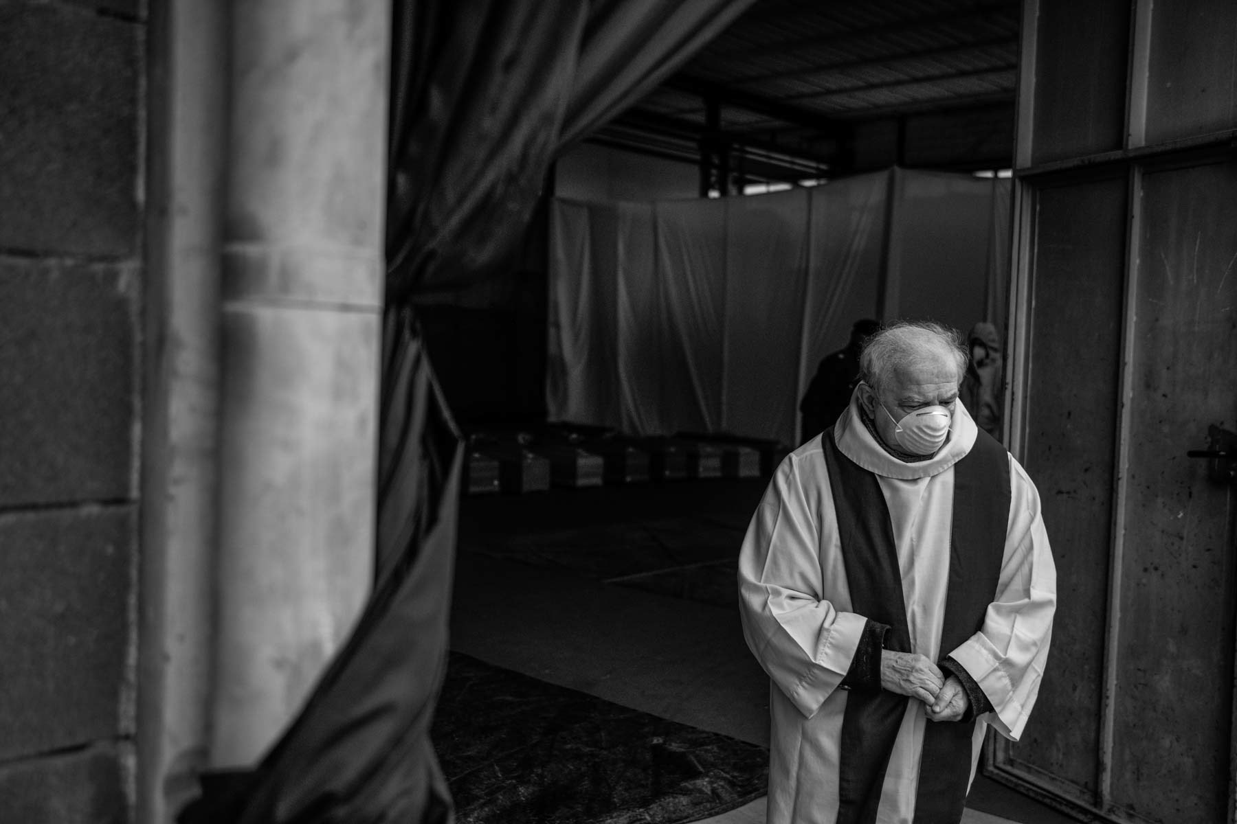 A priest getting out from a emergency morgue