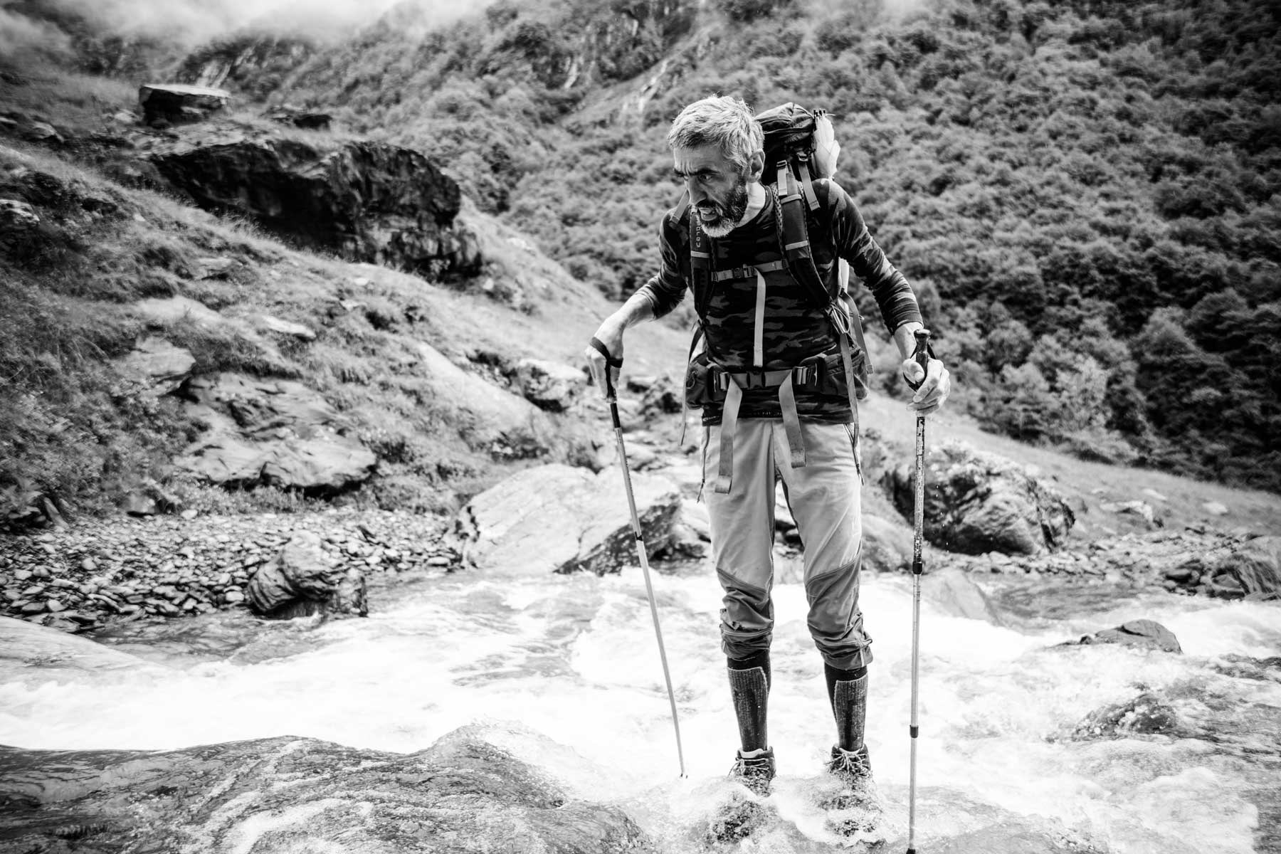 The hut owner crossing the river