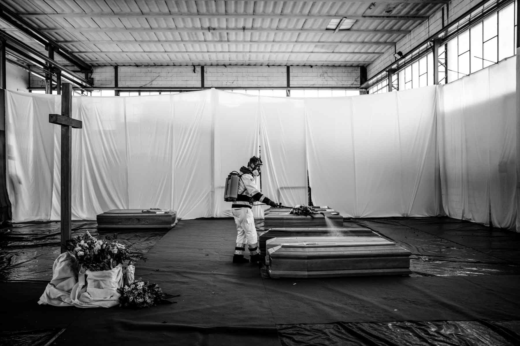 Sanitizing the coffins in the emergency morgue