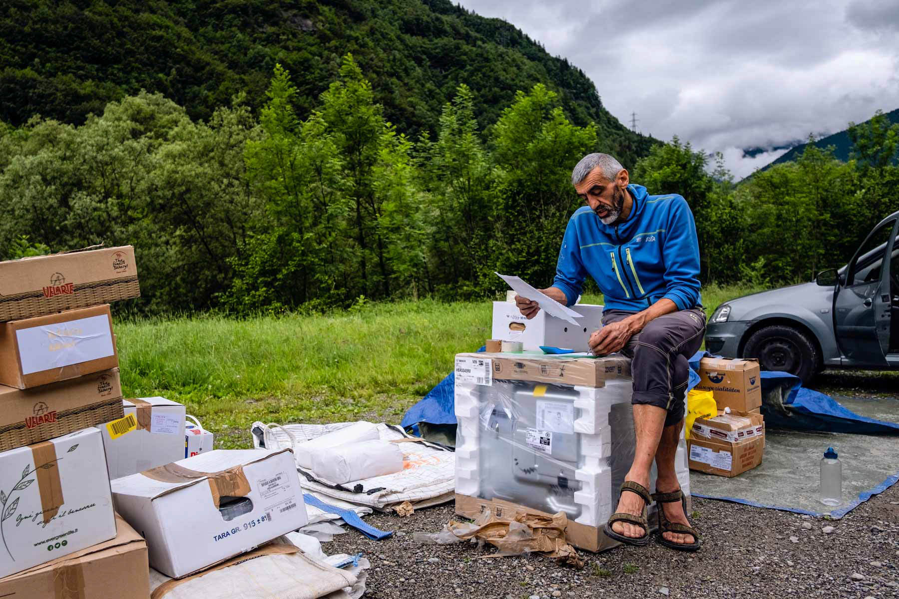 Open air office - Marco is preparing the goods to be loaded on the helicopter