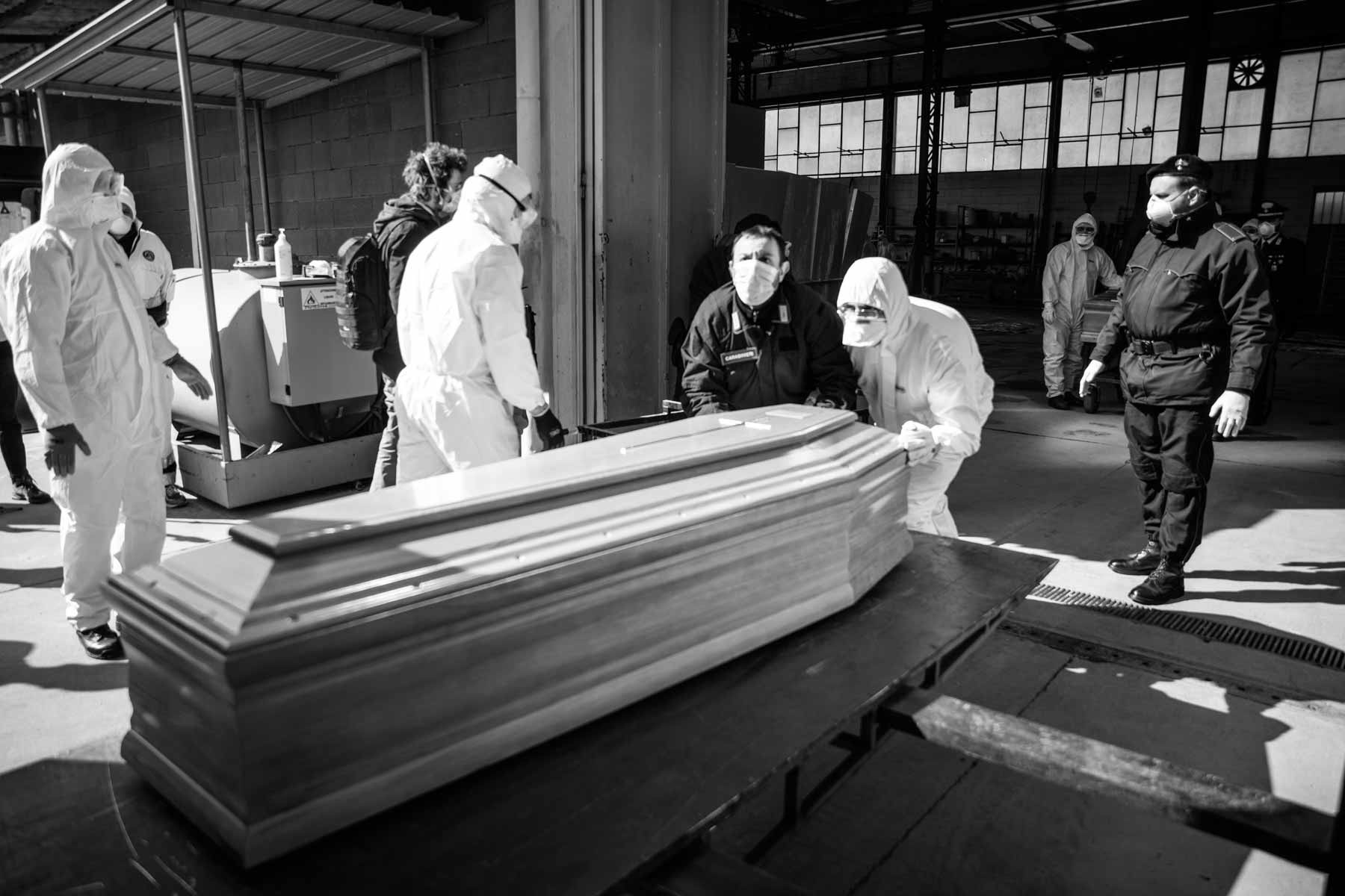Army loading a coffin from the emergency morgue