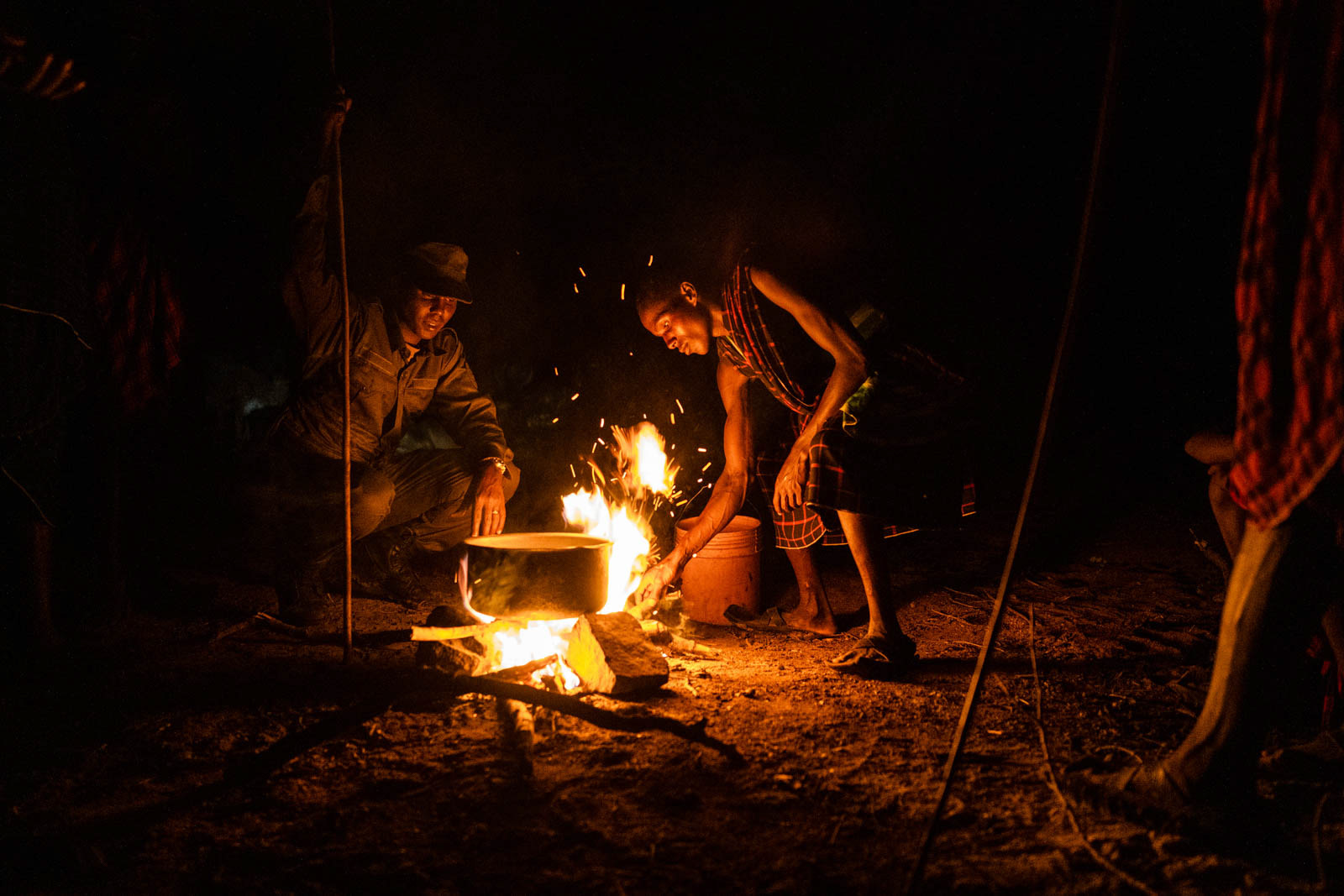 A Maasai ranger talks with a shepherd