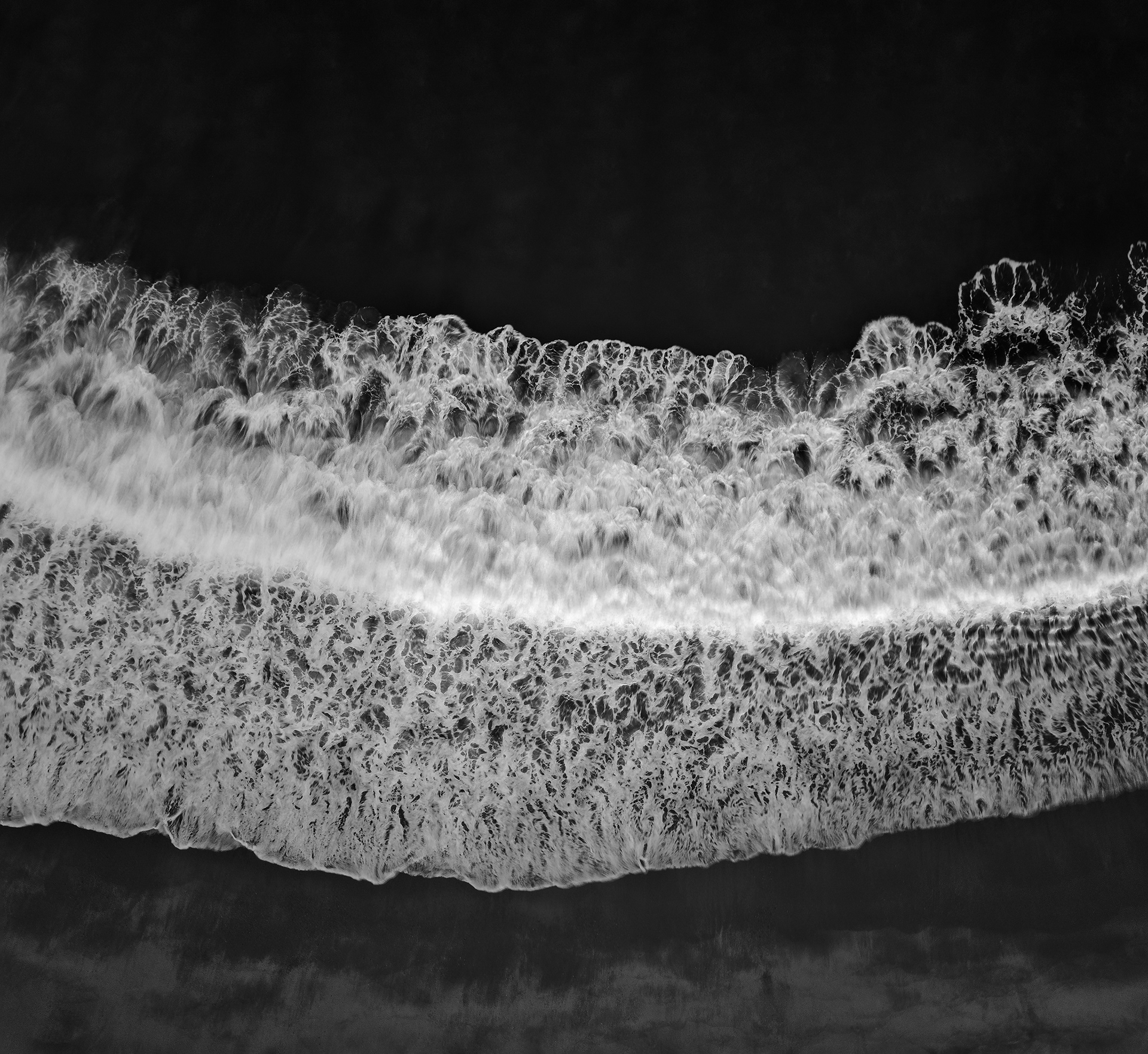Aerial view of sea wave and beach in black and white