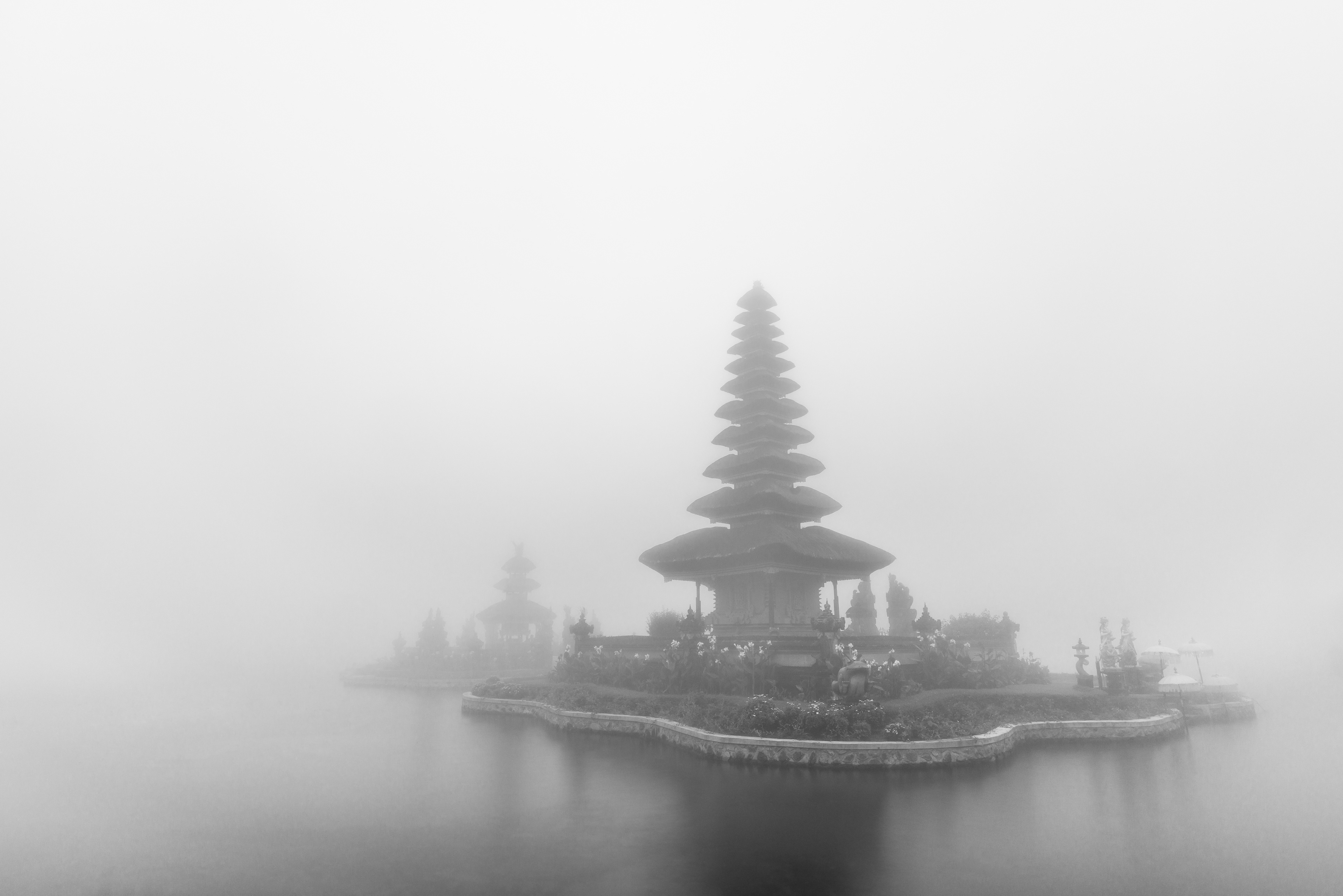 Foggy weather at Pura Ulun Danu Beratan temple in Bali, Indonesia. Black and white.