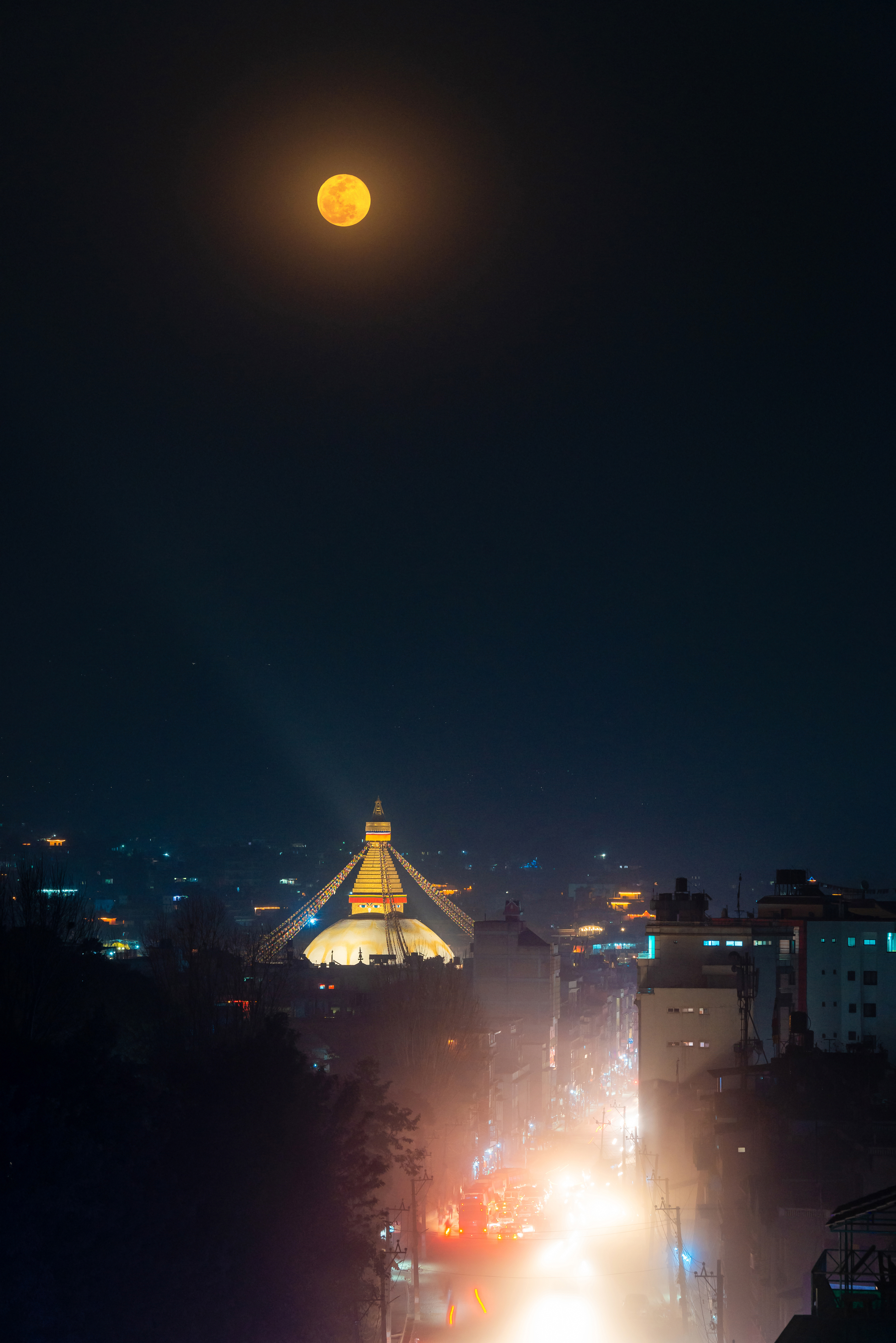 Full Moon over Boudhanath stupa at night in Kathmandu, Nepa