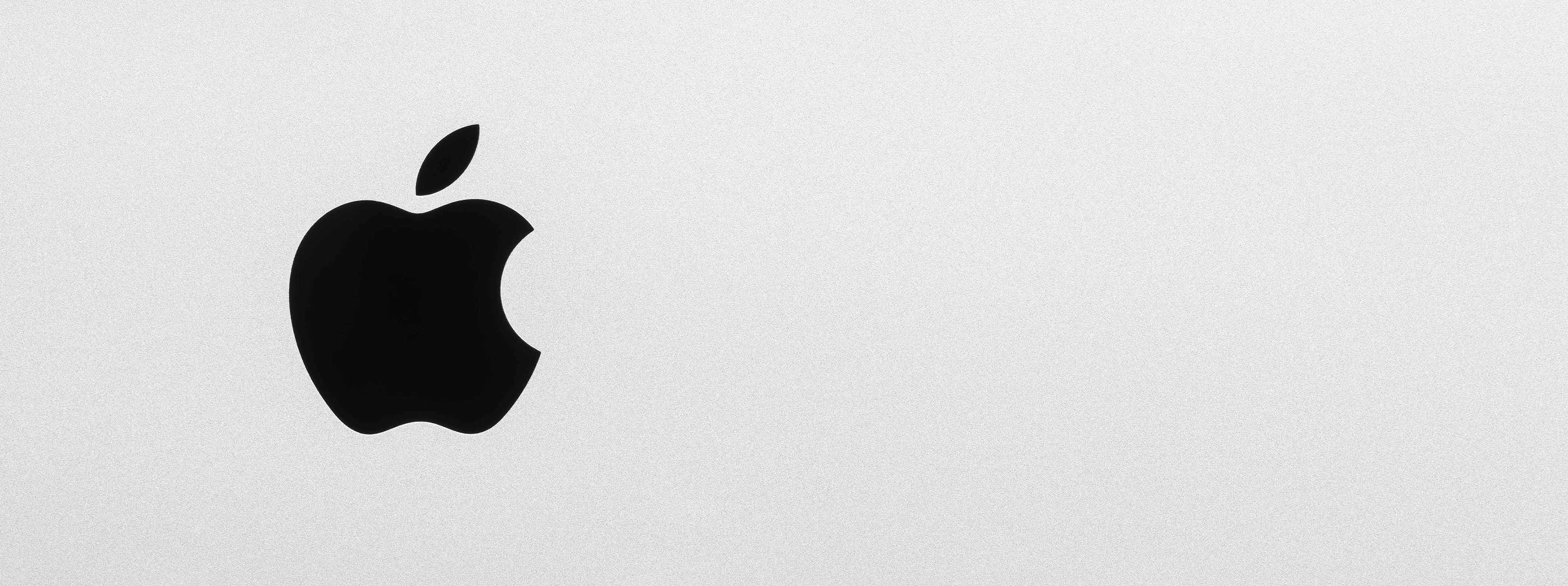Black Apple logo on iMac brushed aluminium background