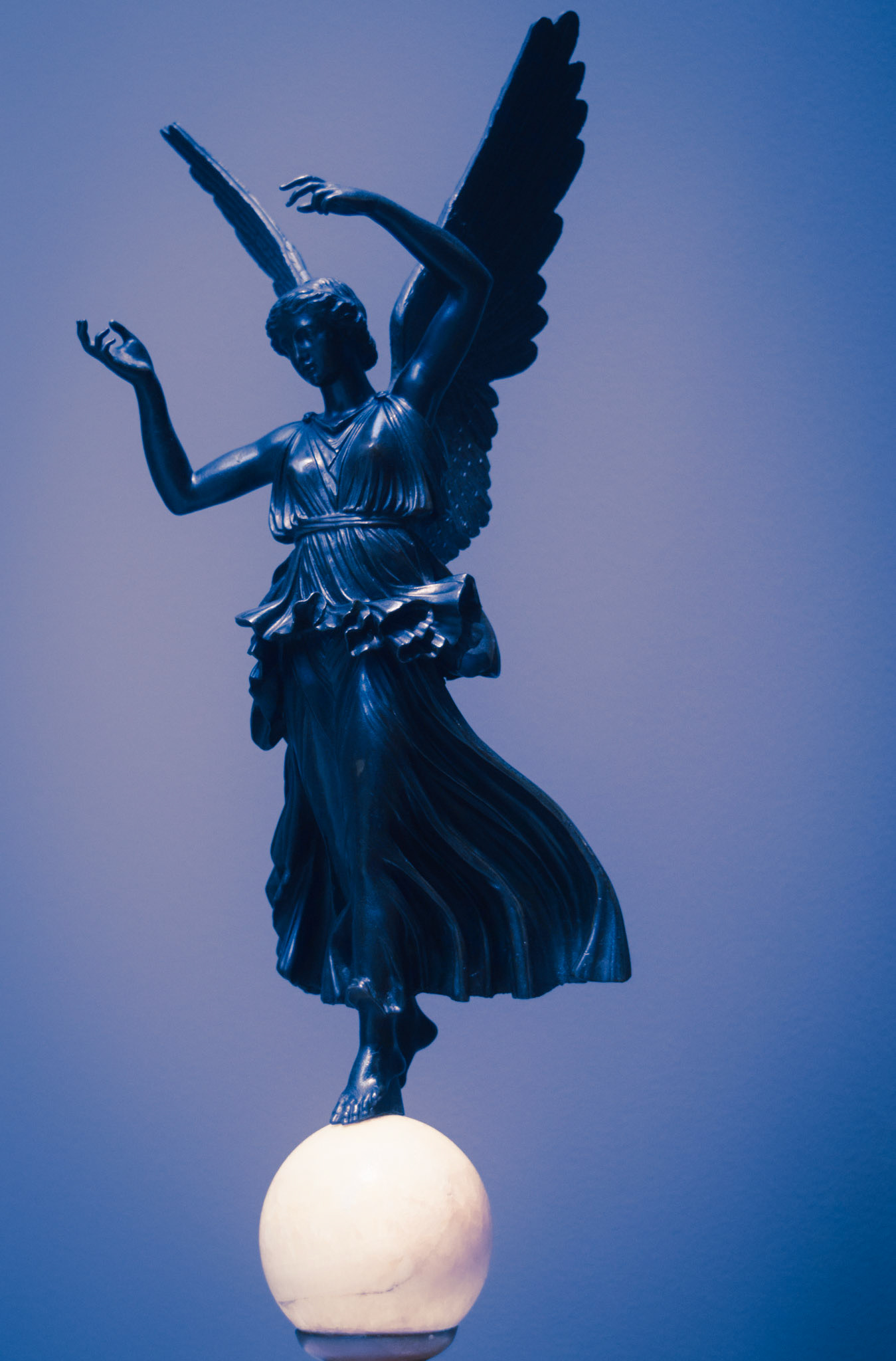 Balancing Angel with Tall Feather in Her Hair