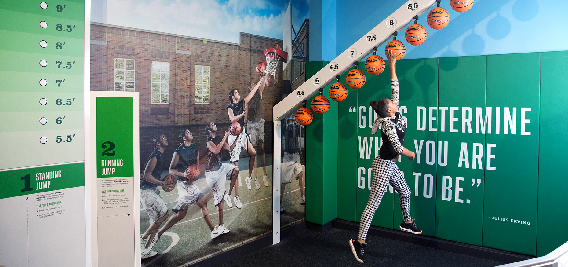 Young woman slam dunking in the SportsZone exhibition.