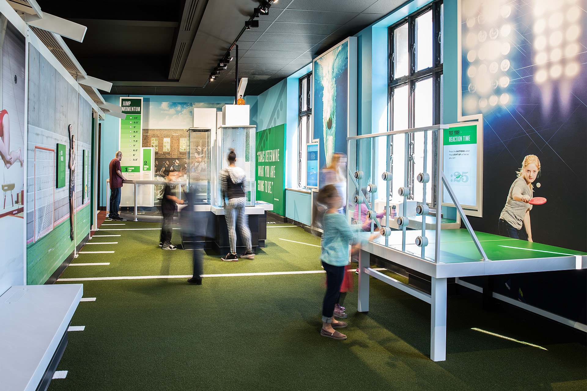 Visitors playing in the "GO!" section of the exhibition.