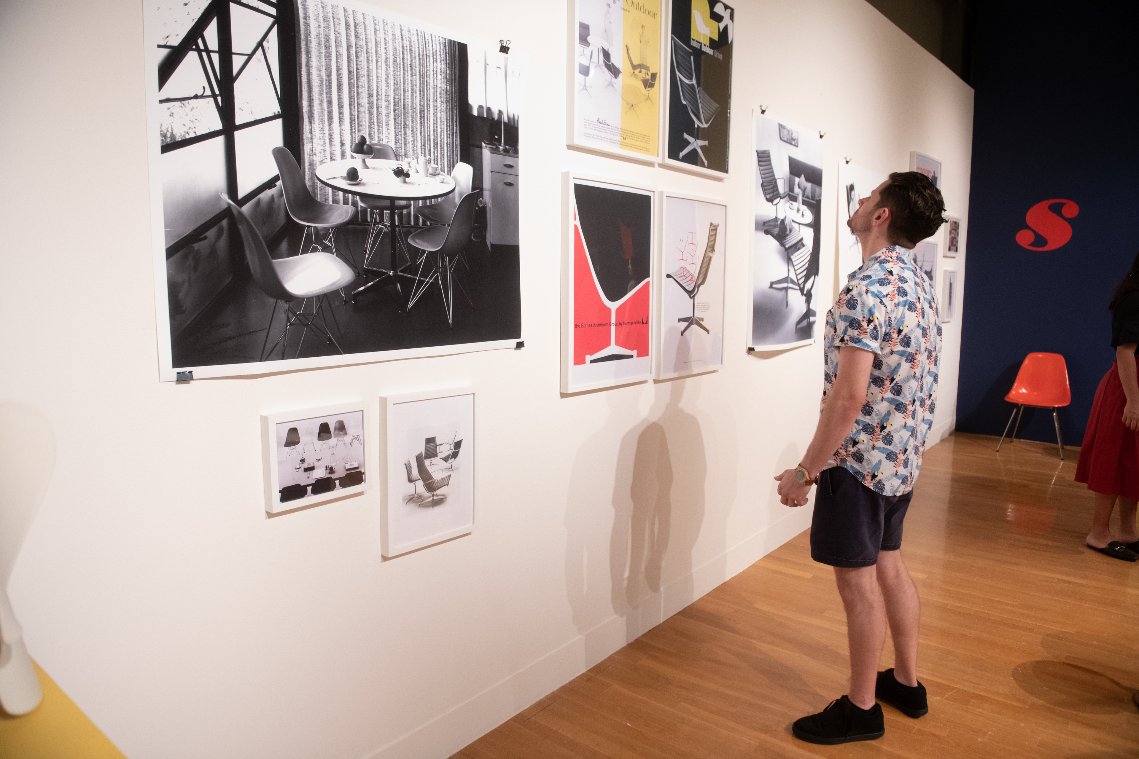 Visitor looking at the wall of posters.